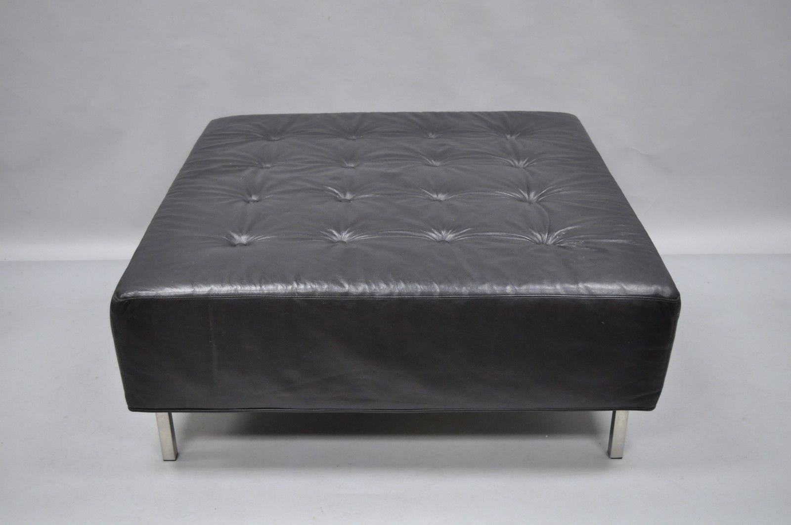 Thayer Coggin black tufted leather ottoman. Item details tufted leather upholstery, original label, metal legs, clean modernist lines, and quality American craftsmanship, circa 2005. Measurements: 16