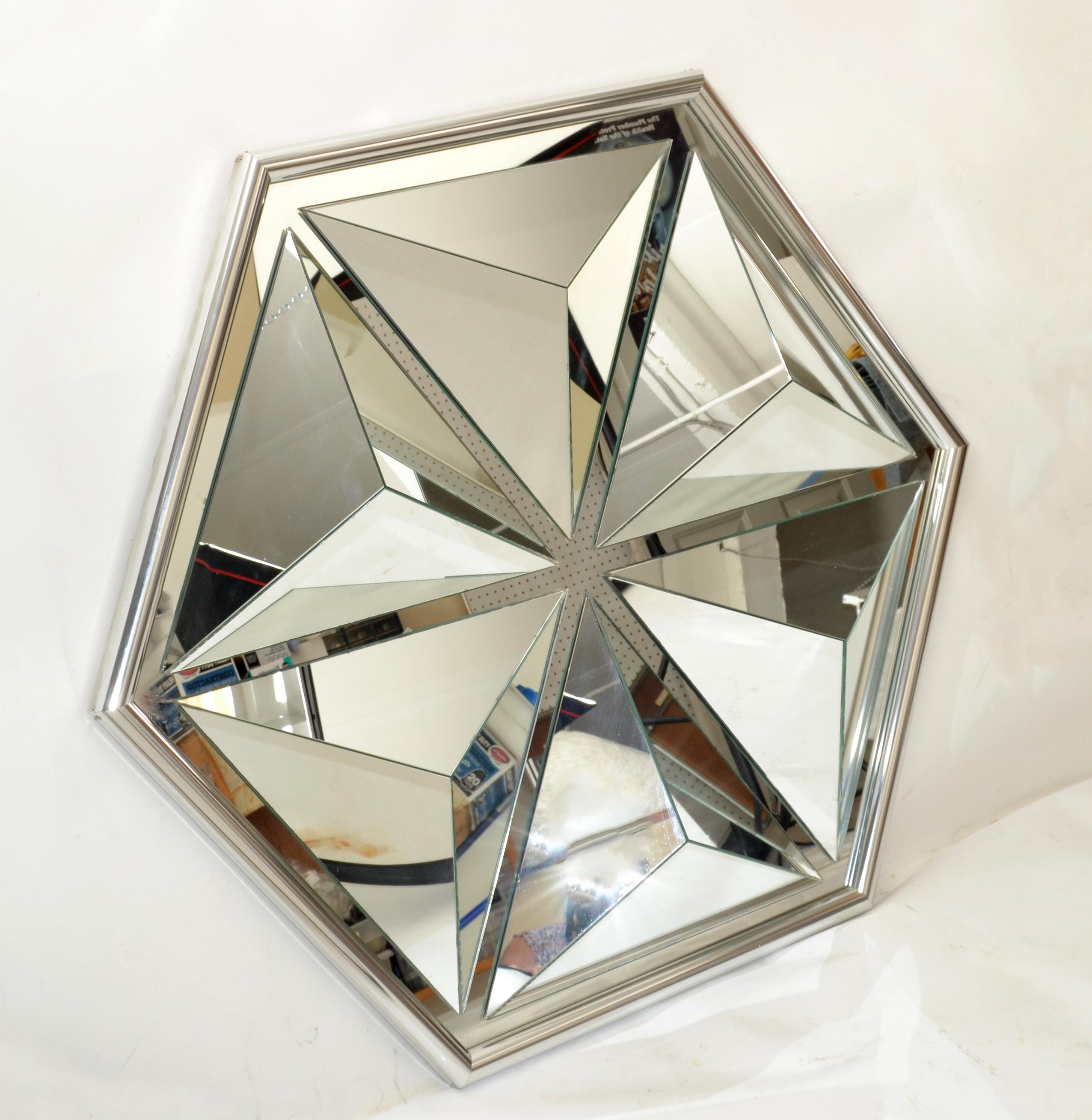 One-of-a-kind diamond shaped faceted wall mirror made in the USA in the 1976.
Hand painted silver finish frame.
Mid-Century Modern design for any interior.
Secure hanging construction and supported by the wood backboard.
