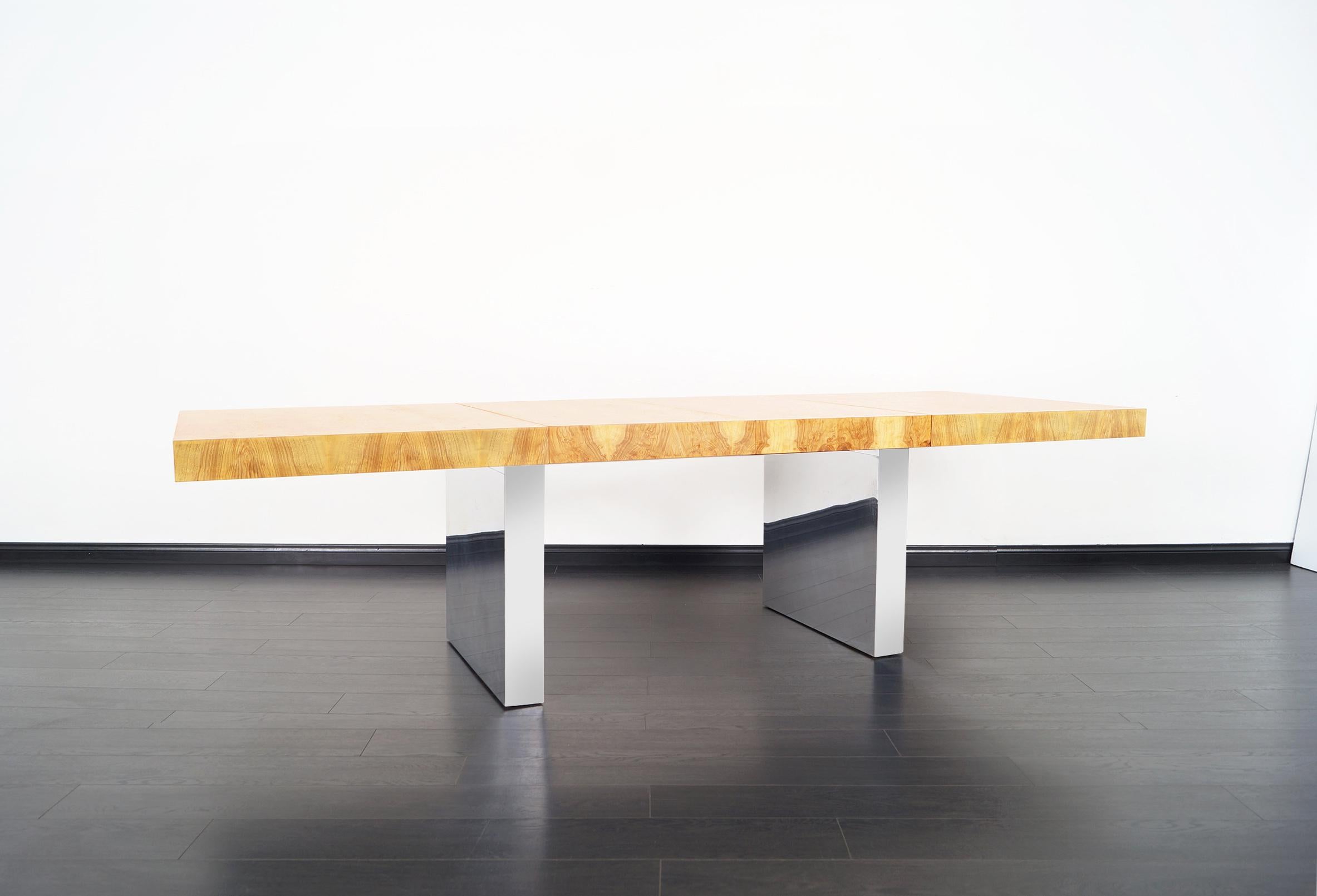 Incredible vintage burl wood dining table designed by Milo Baughman for Thayer Coggin. Its versatile design allows it to serve as a dining table, conference table, or desk. Features a burl wood top that sits over a pair of rectangular chrome