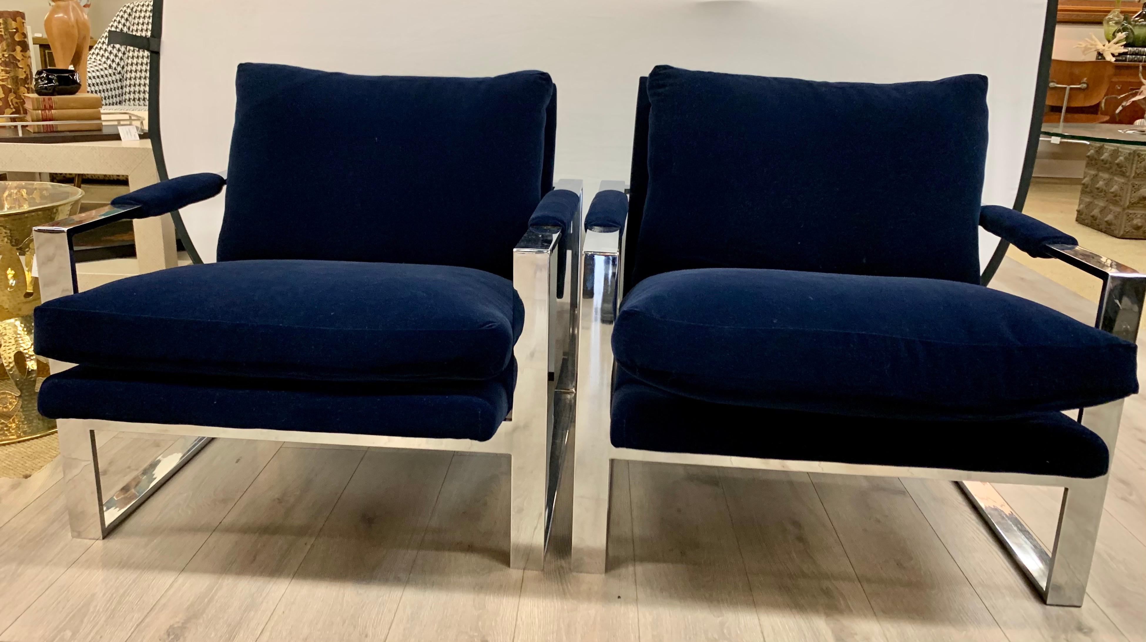 Newly upholstered in a luxurious solid navy velvet, this matching pair of mid century polished steel cube chairs are sure to impress. These chairs are heavy and have lines to die for. All dimensions are below. Now, more than ever, home is where the