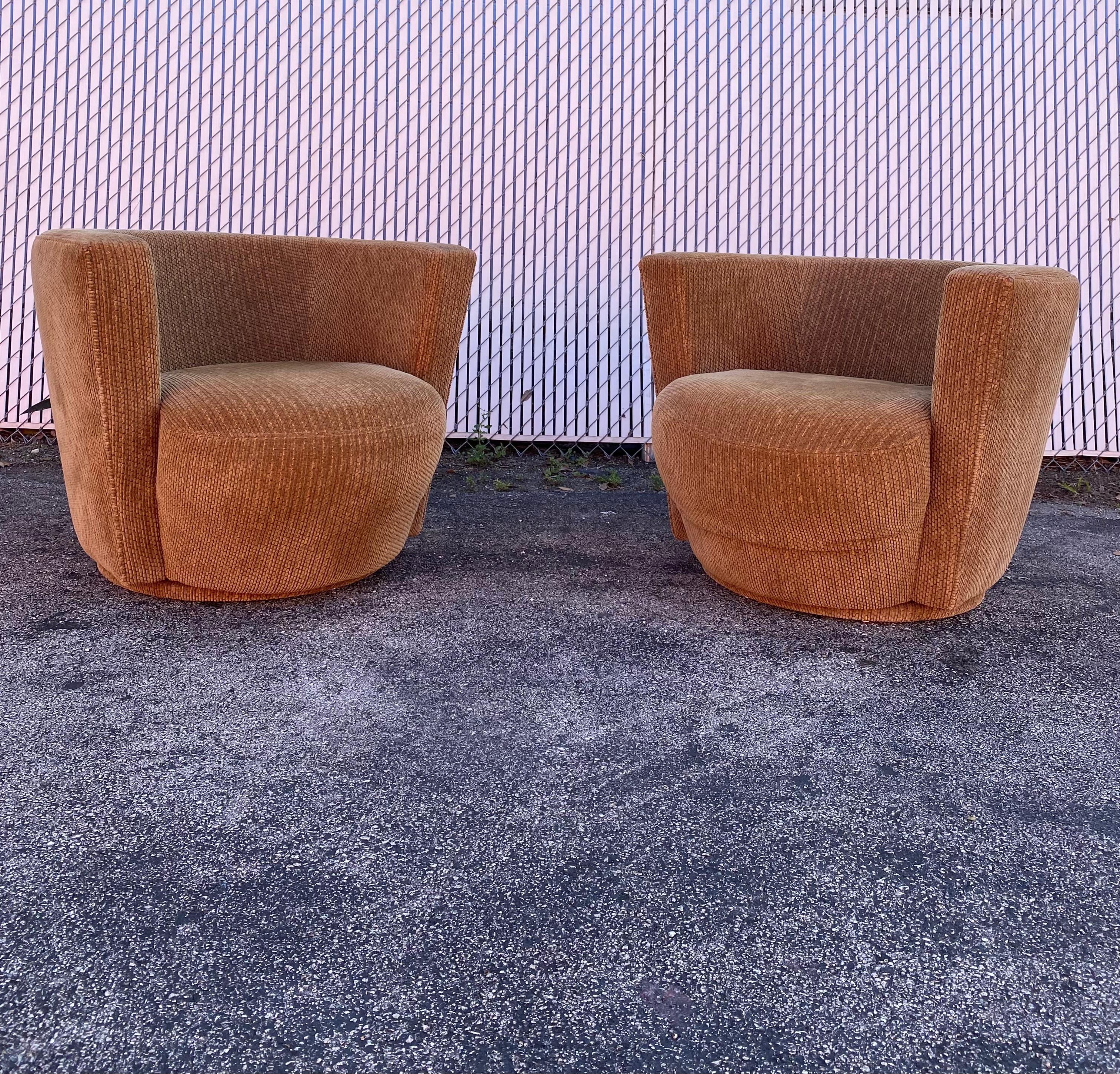 These iconic stylish original upholstered swivel chairs are packed with personality! Outstanding design is exhibited throughout the monumental form. Their beautiful and unique shape are designed by Ransom Culler. The chairs feature a comfortable