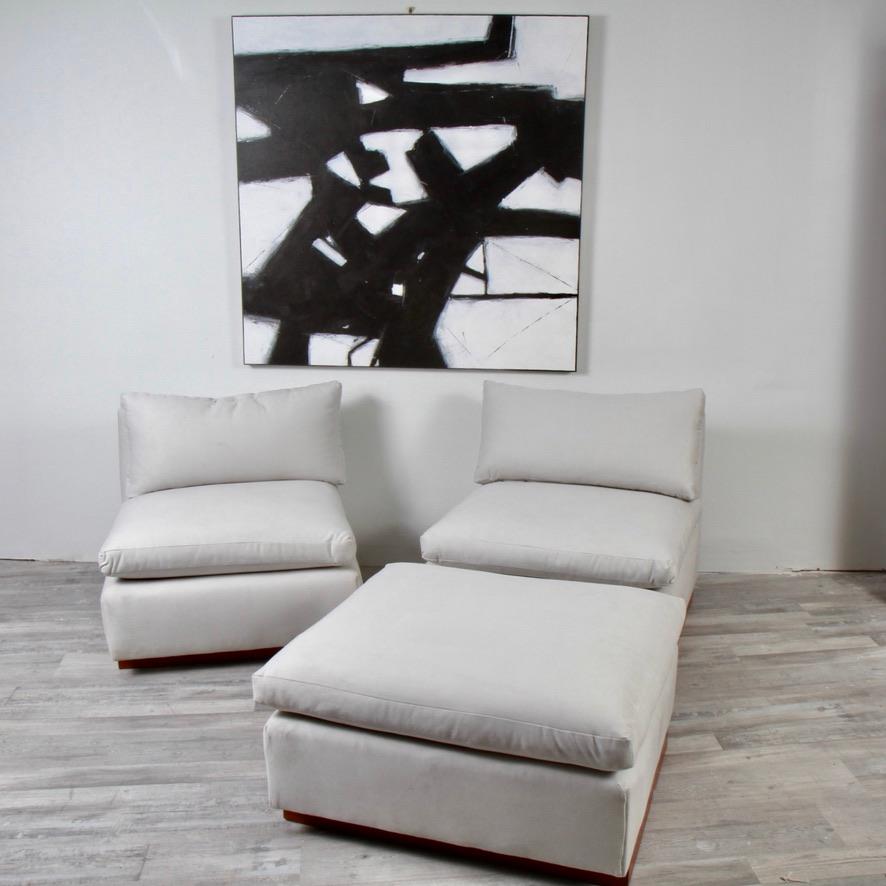 A pair of survivors from the 80s. Could have been part of a sectional set. Very reminiscent of Milo Baughman/Thayer Coggin sets of the same era. This 3-piece set has just been recovered in a very pale grey with a bit of an ultra suede feel to the