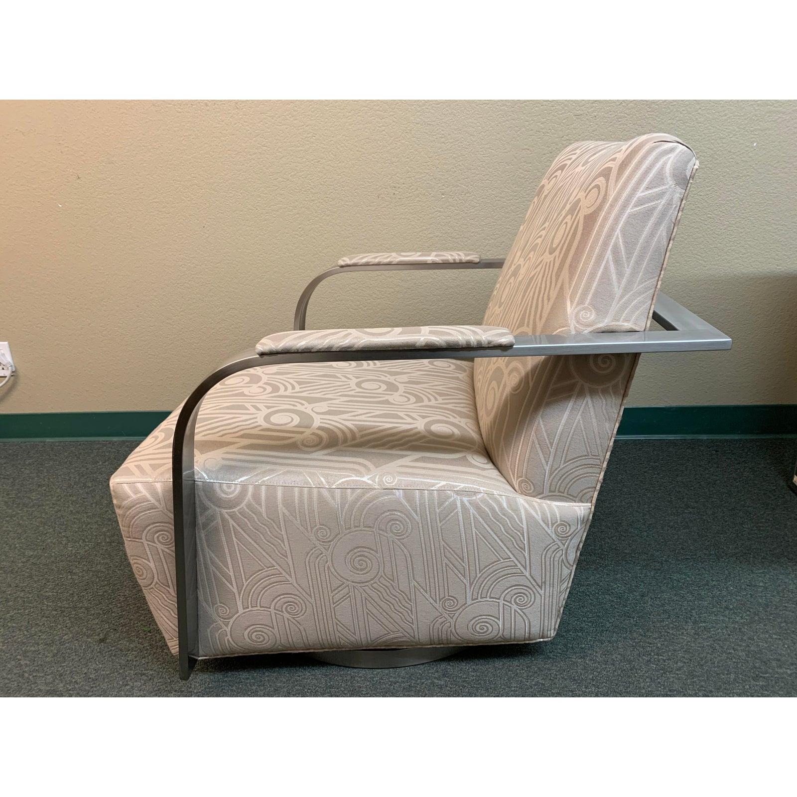 Presents the Zac Swivel chair by Thayer Coggin. This swivel chair is a new modern Classic designed by Ransom Culler for Thayer Coggin, and features a neutral patterned upholstery, a memory swivel base and sleek metal arms and base of brushed