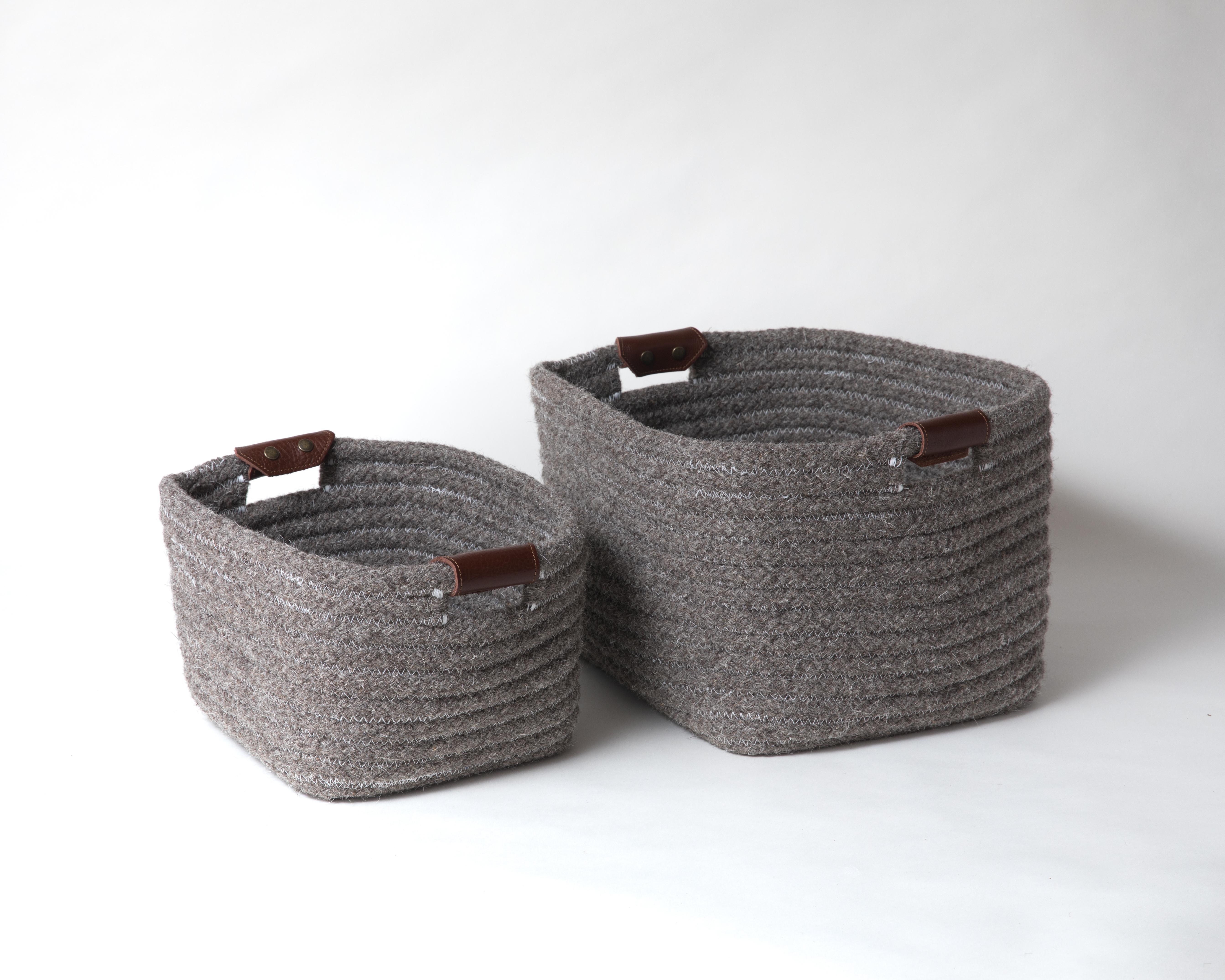 Simple and sturdy woven basket in a rectangular design. Dark Grey, natural un-dyed wool is accented with leather handles. Handle color options are brown, black and natural. 

Designed by Meredith Thayer in her South Boston studio and made to order