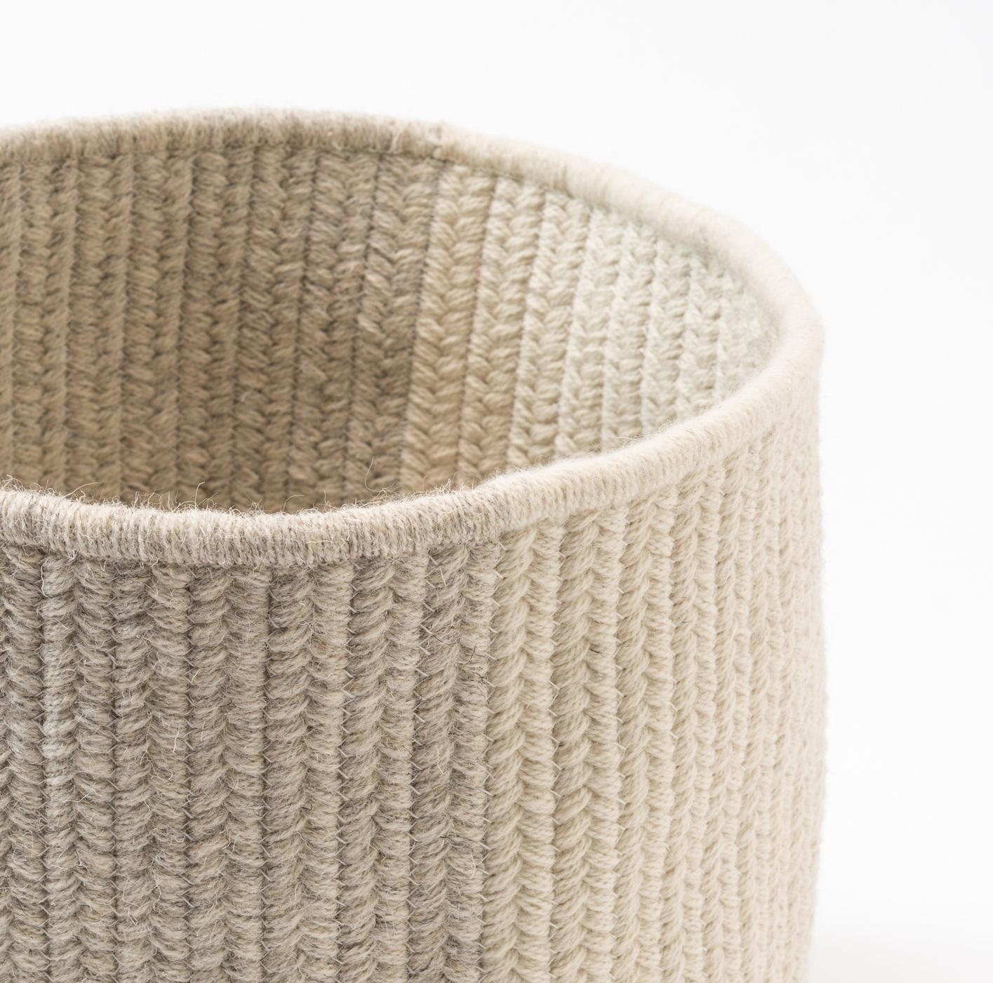 Vertical flat woven braids combine contrasting tones in this round basket. Light grey and cream natural un-dyed wool yarns sewn with white cotton thread.

Designed by Meredith Thayer in her South Boston studio and made to order in Rhode Island. We