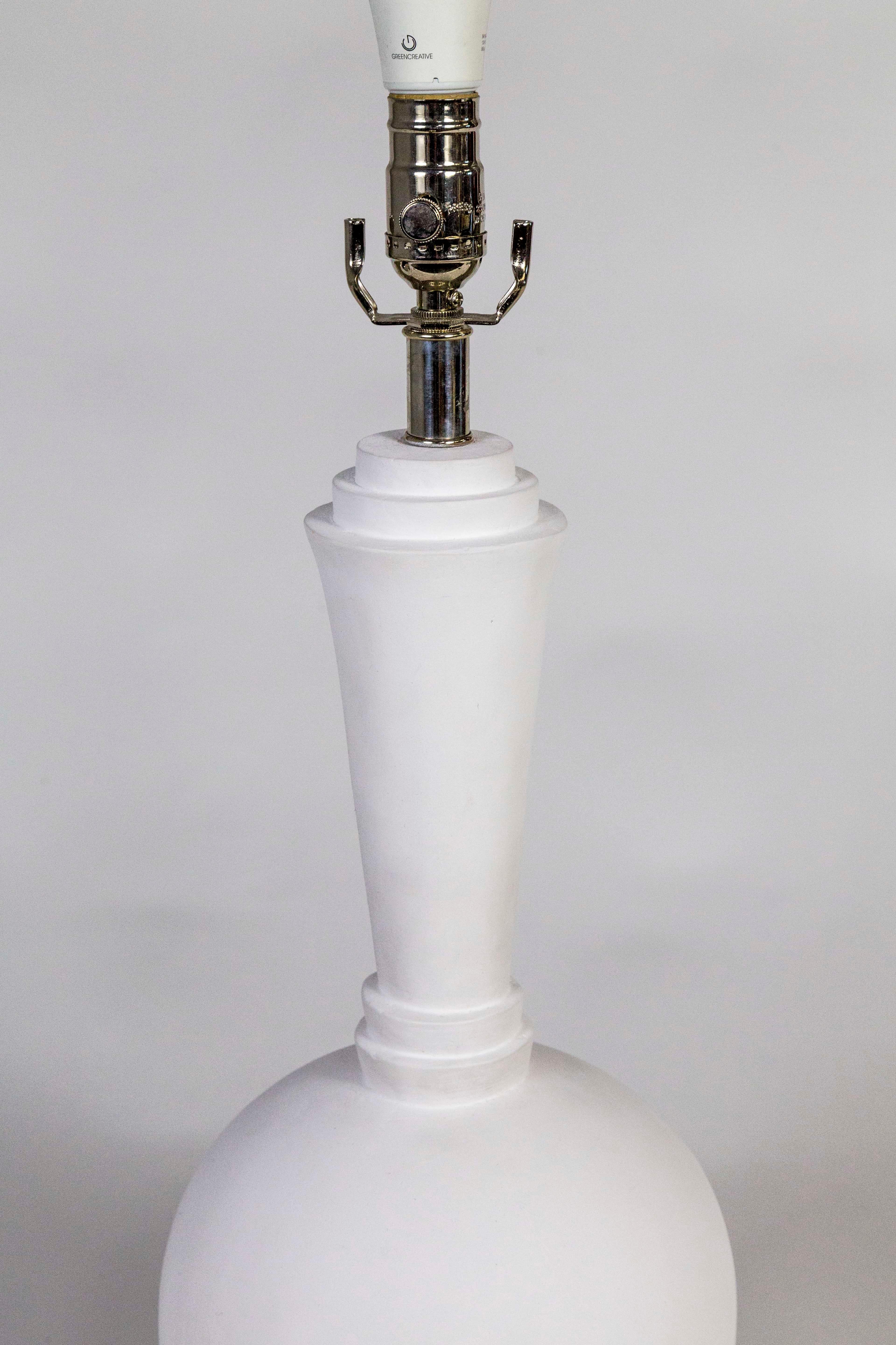 A modernist, molded plaster table lamp in the style of Francis Elkins, fabricated in the 2010s by Ismay and Company San Francisco. With an acrylic base, polished nickel hardware, and 3-way socket; newly wired. Measures: 24” to top of socket 9.5”