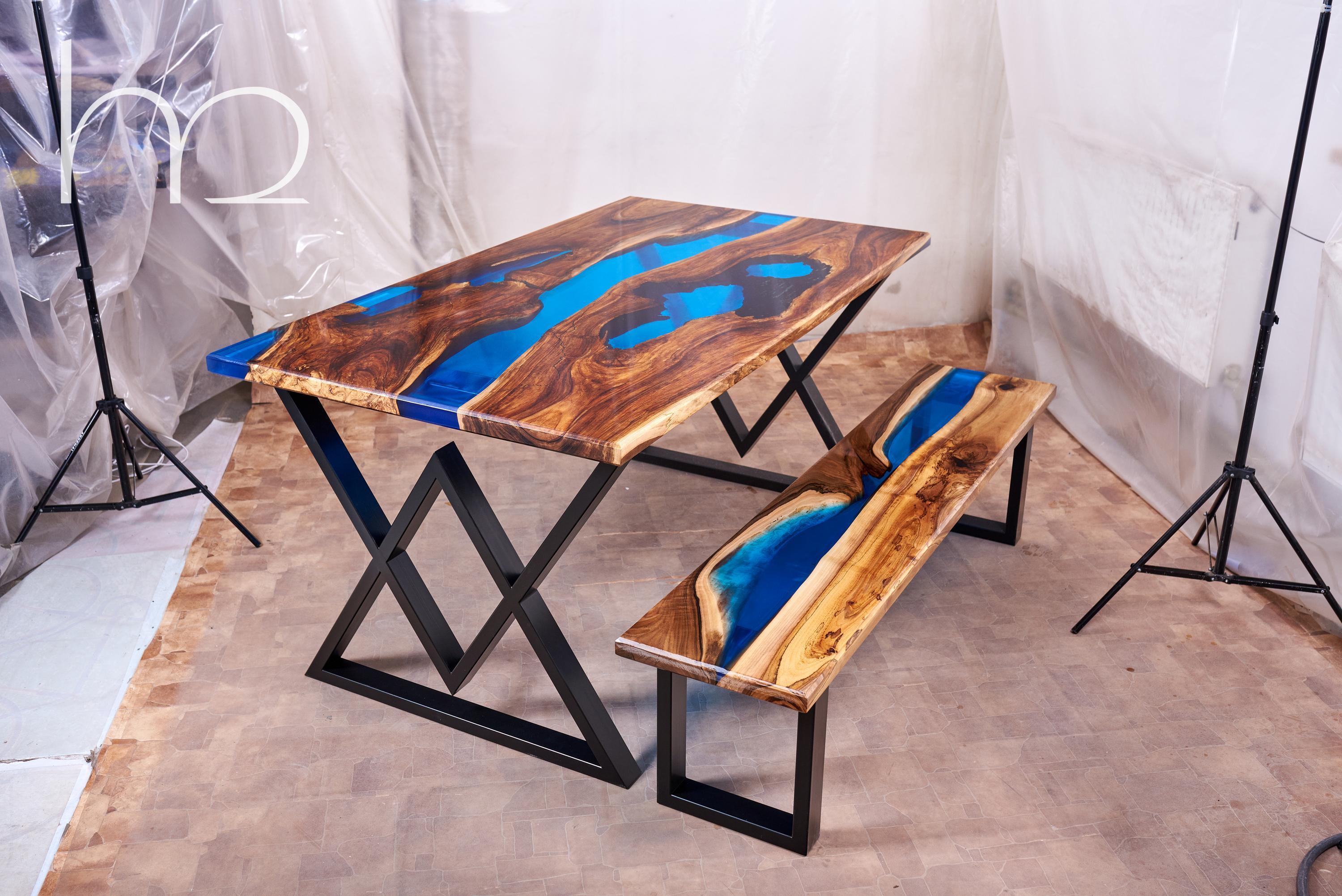 When I made this table, the main challenge was to find really old walnut slabs. So that they would be dark, with a rich dark vein, a little rotten and with lots of holes and cracks. The resin color had to be a clear blue and it's cool to find wood