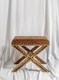 The Alexander X-Frame stool, upholstered in Leopard Velvet with nailing detail