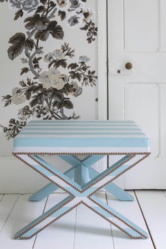 The Alexander X-Frame stool, upholstered in striped silk with nailing detail