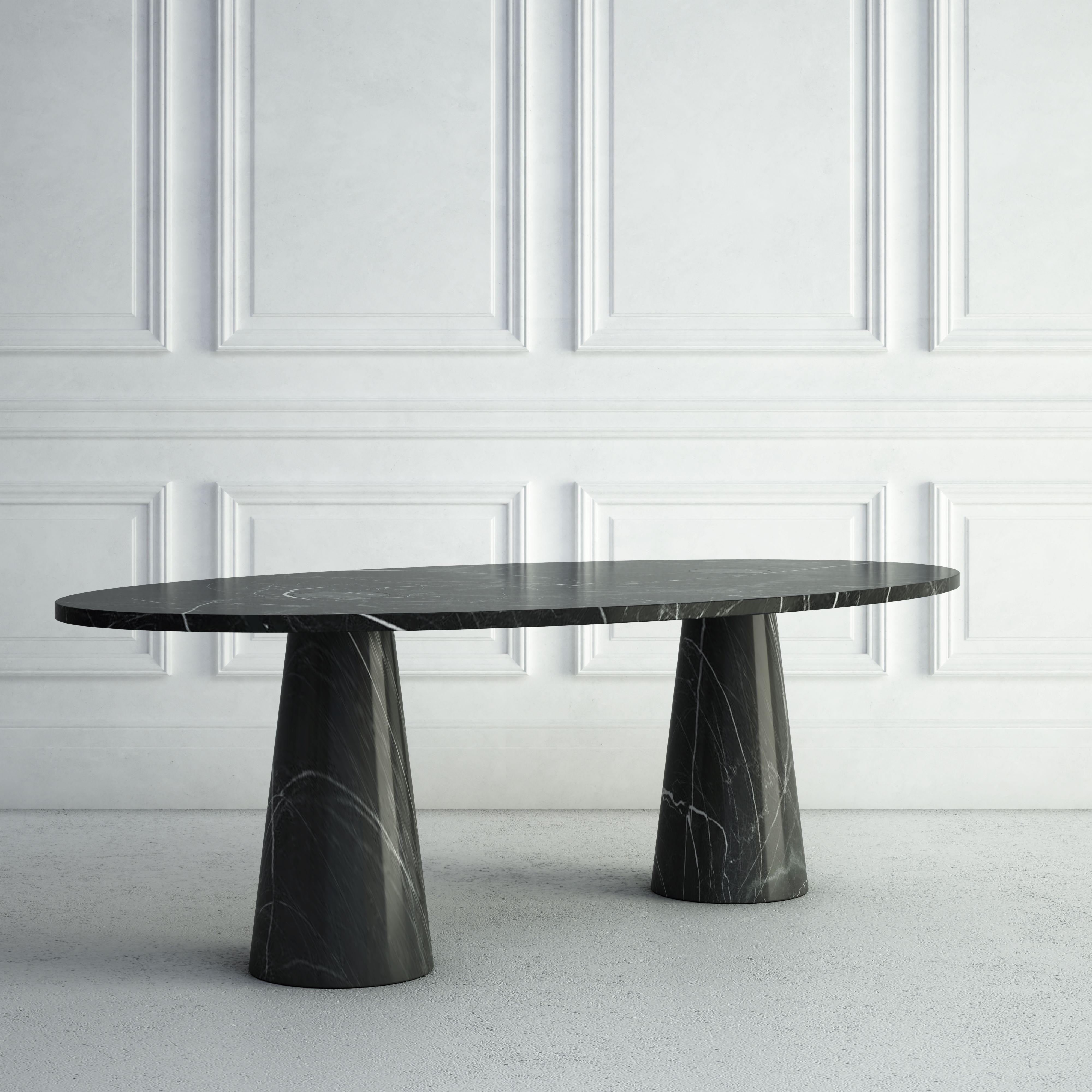 The Amandine is a bold modern dining table.  The top is made from an elegant thin oval stone slab.  Each base is circular, but tapers up into a large conical shape supporting the top, giving the table a stylish but fun look.  The same stone is used