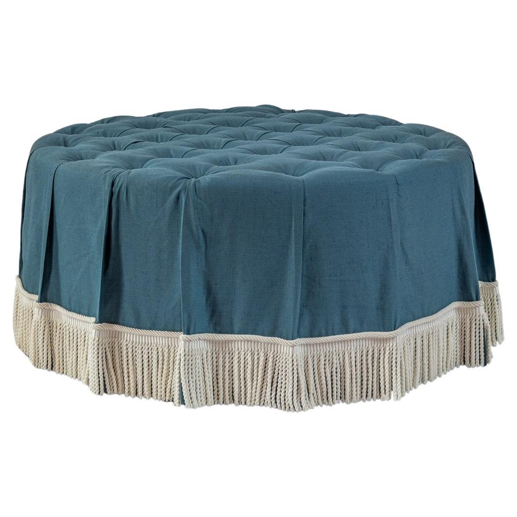 The Amelia Ottoman in deep buttoned blue linen, ticking stripe & bullion fringe