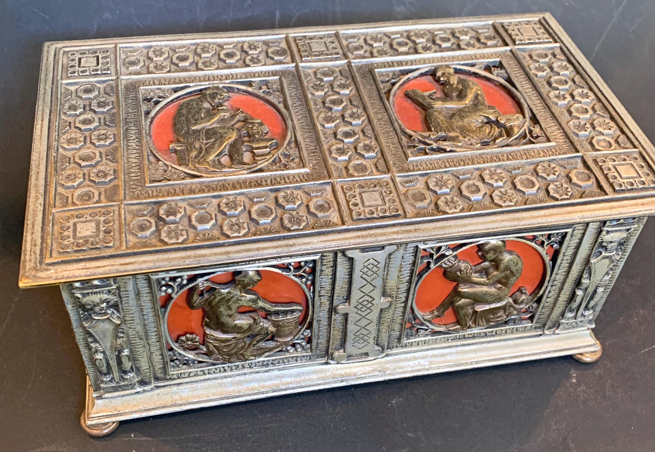 Beautifully detailed with symbols of the arts, including literature, sculpture, pottery and spinning, this silvered bronze casket with hinged lid and mahogany interior was produced by the famed Oscar Bach studios in New York City. In addition to a