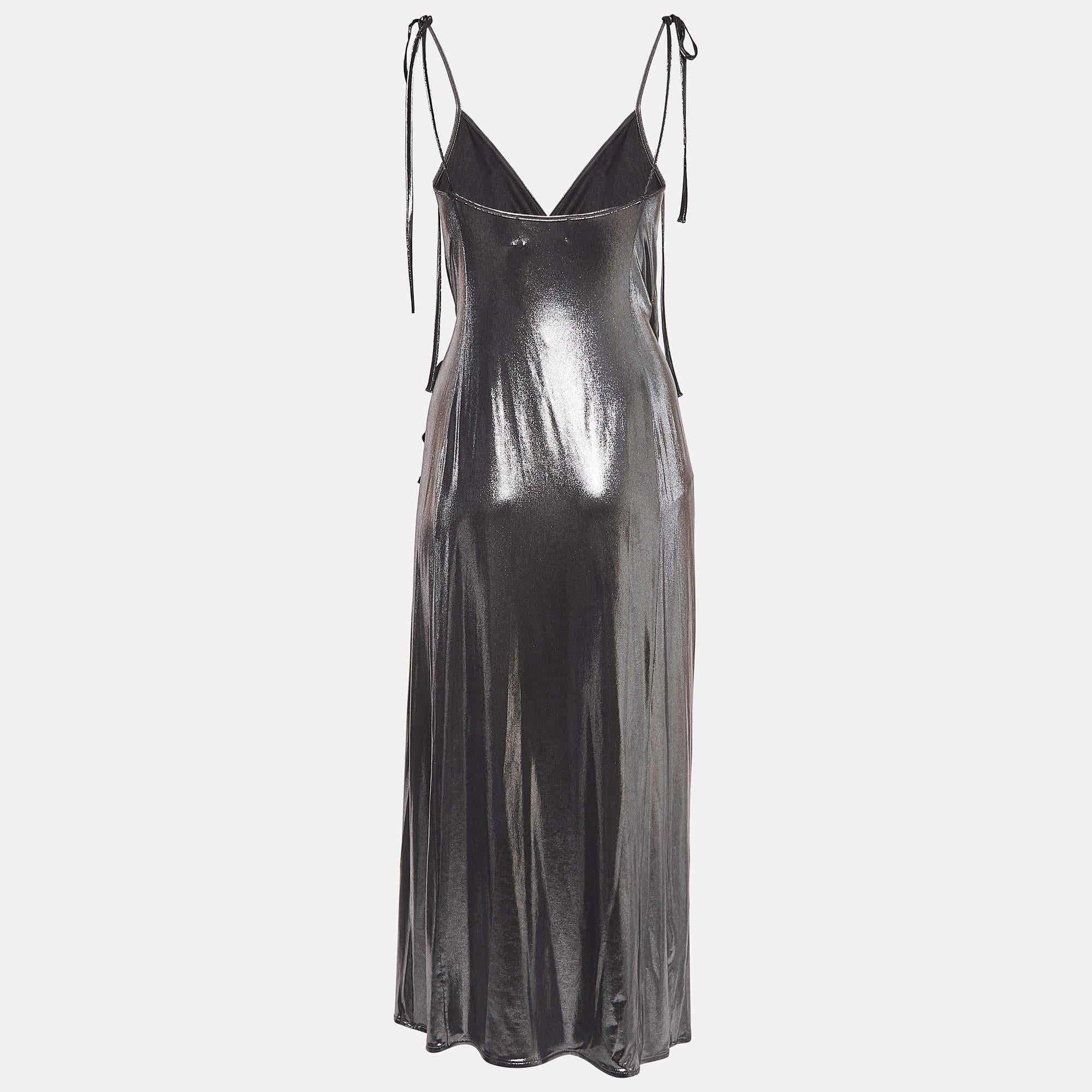 Shimmer in The Attico dress designed with a striking fan detail for a dramatic flair. This long fluid silhouette offers a bold touch of glamour with its metallic sheen making it a show stopping choice for special occasions. A true statement piece it