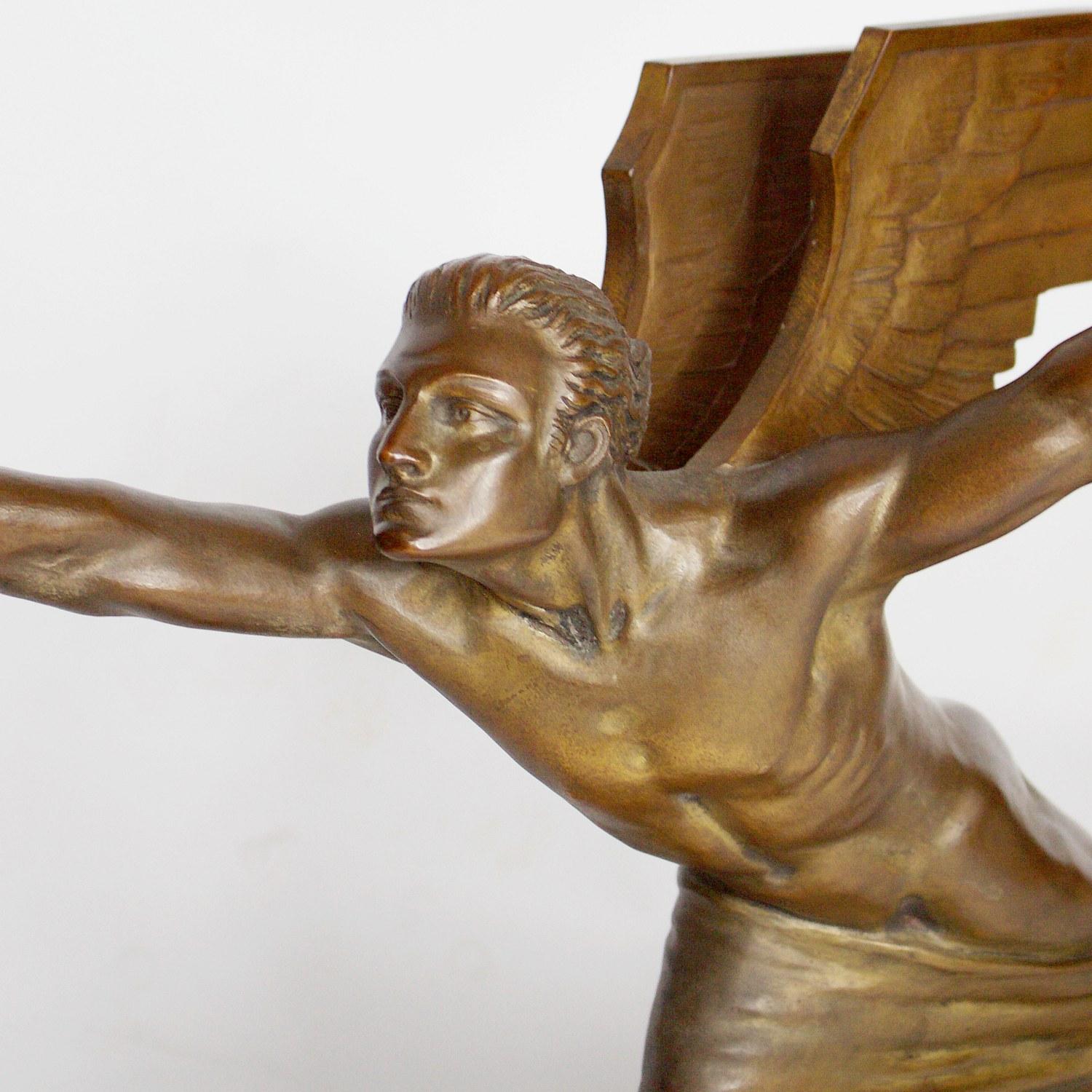 An Art Deco bronze sculpture 'The Aviator' by Frederic Focht (1879-1938) of a rocket propelled winged man reaching for the stars. Excellent original golden brown patination with original gilding to wings. Set atop original black polished marble
