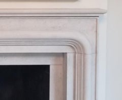 The Balzac:  A Transitional Stone Fireplace with a Bold Curving Frame
