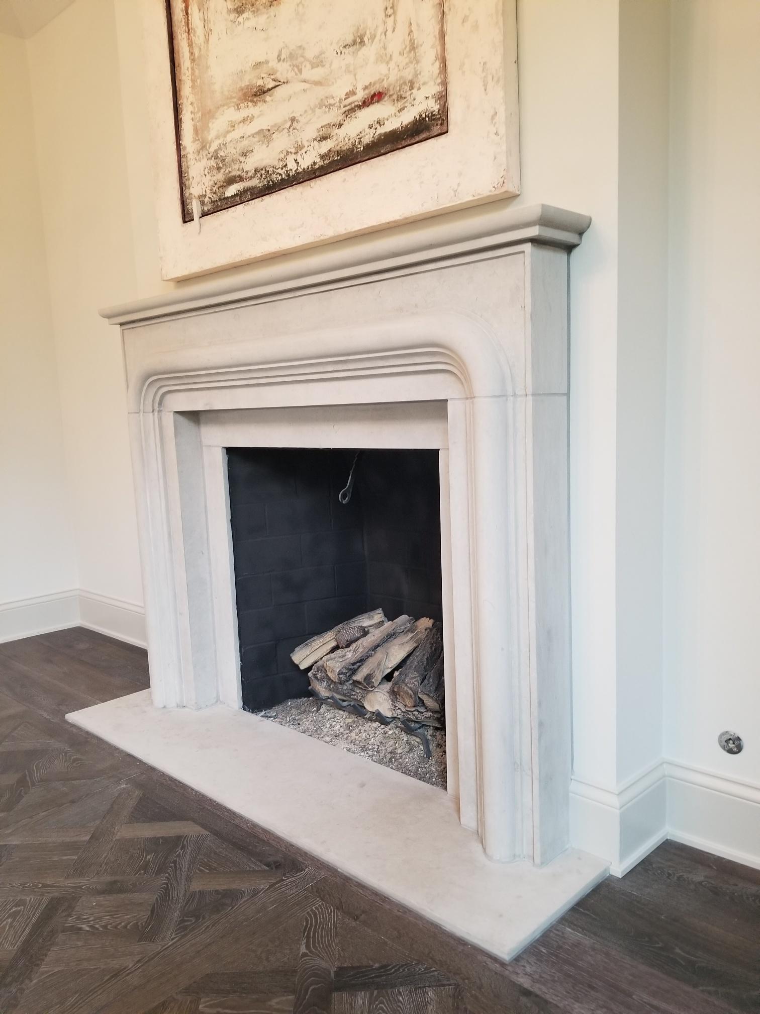 Carved The Balzac:  A Transitional Stone Fireplace with a Bold Curving Frame For Sale