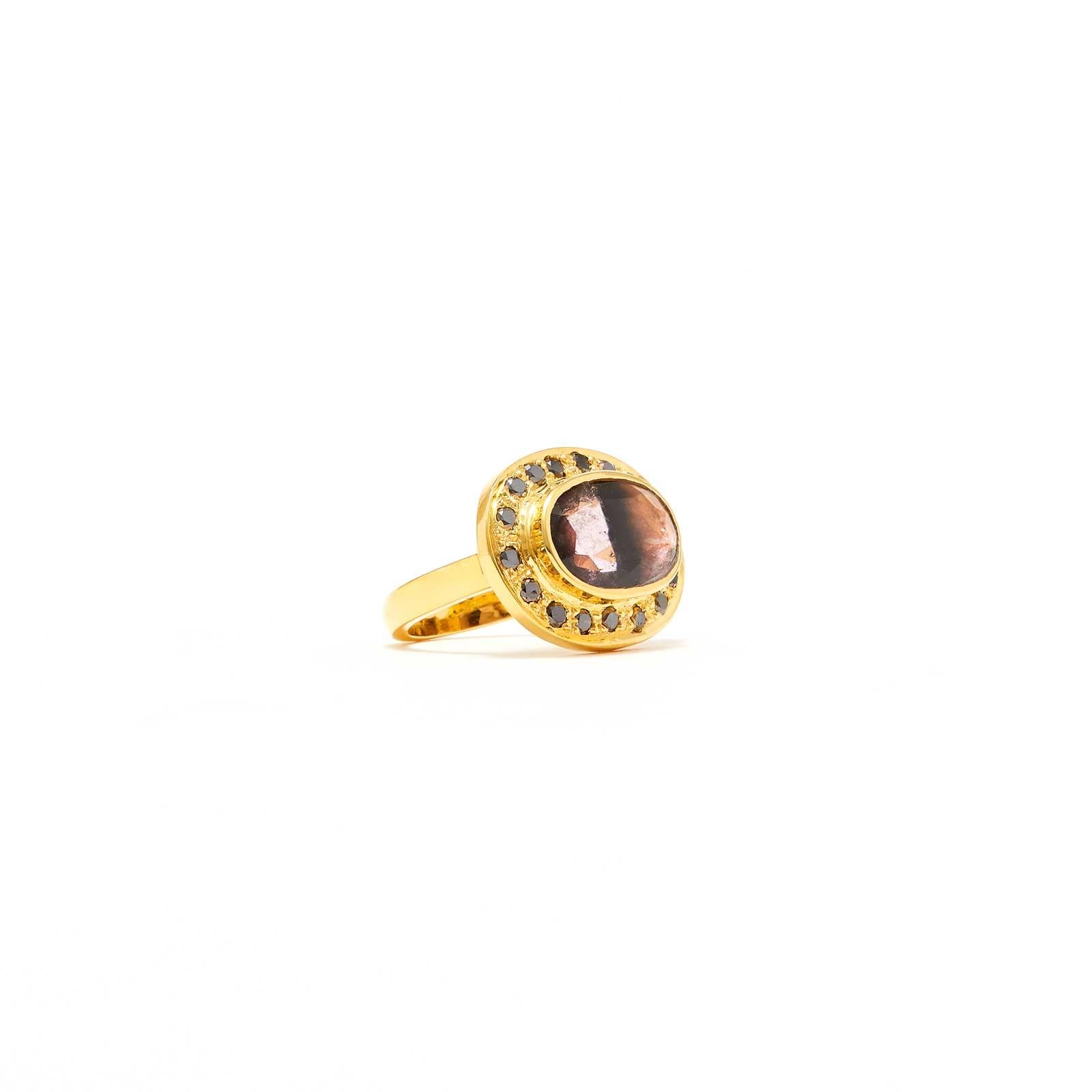 A beautiful Mauve hued Black Stripe Tourmaline accented with Black Diamonds in a Gold oval setting. An exceptional dress ring of classic design reimagined with a modern twist.

- Natural Mauve hued Black Stripe Tourmaline weight approx 2.20