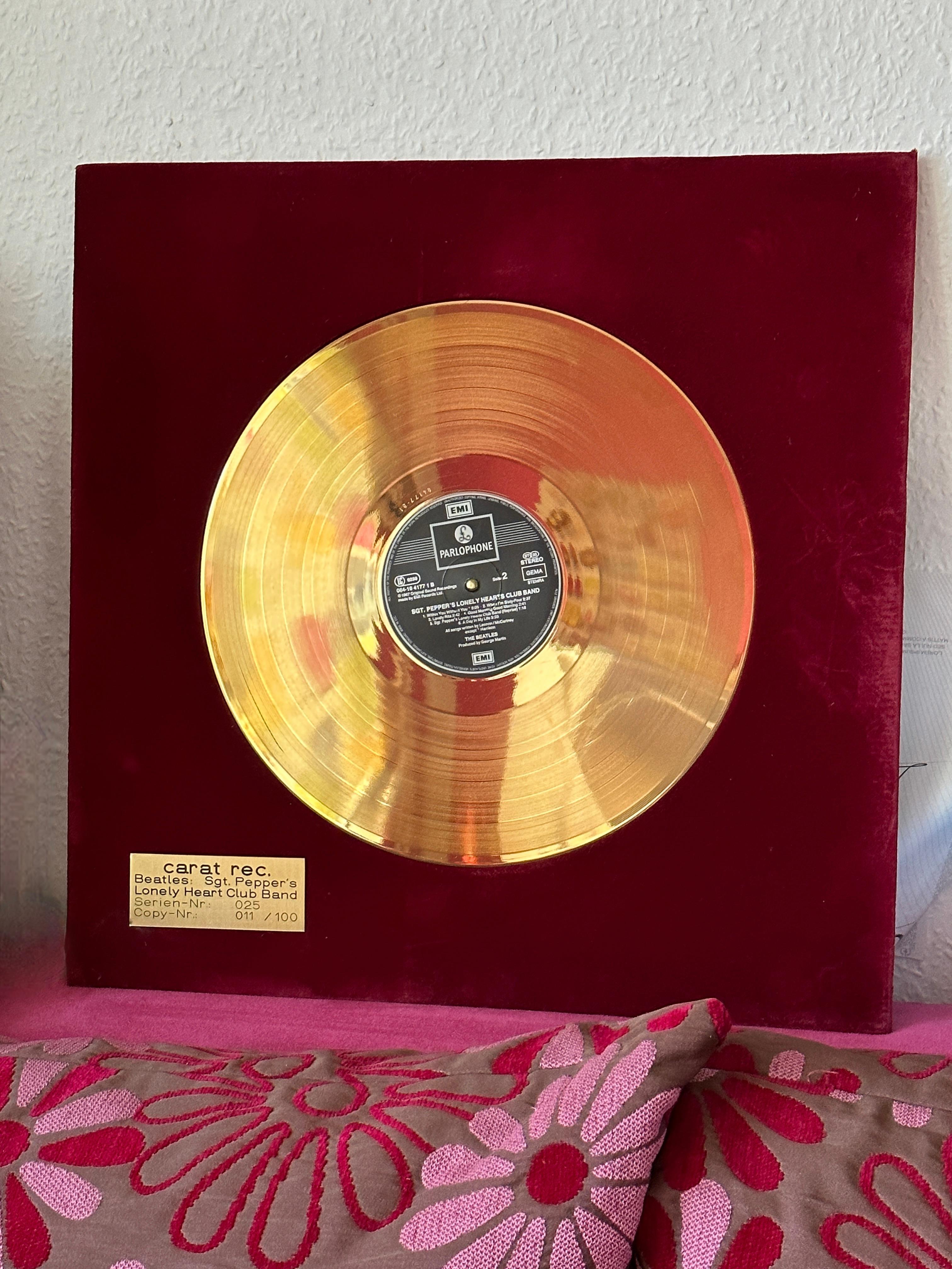 1970s The Beatles 24-karat gold-plated record, unframed. Limited edition of 100, 11/100 with “Certificate of Authenticity” included. Golden Record on a red Velvet wooden plate. Nice to hang at a wall or have it framed for display. Record Emi Records
