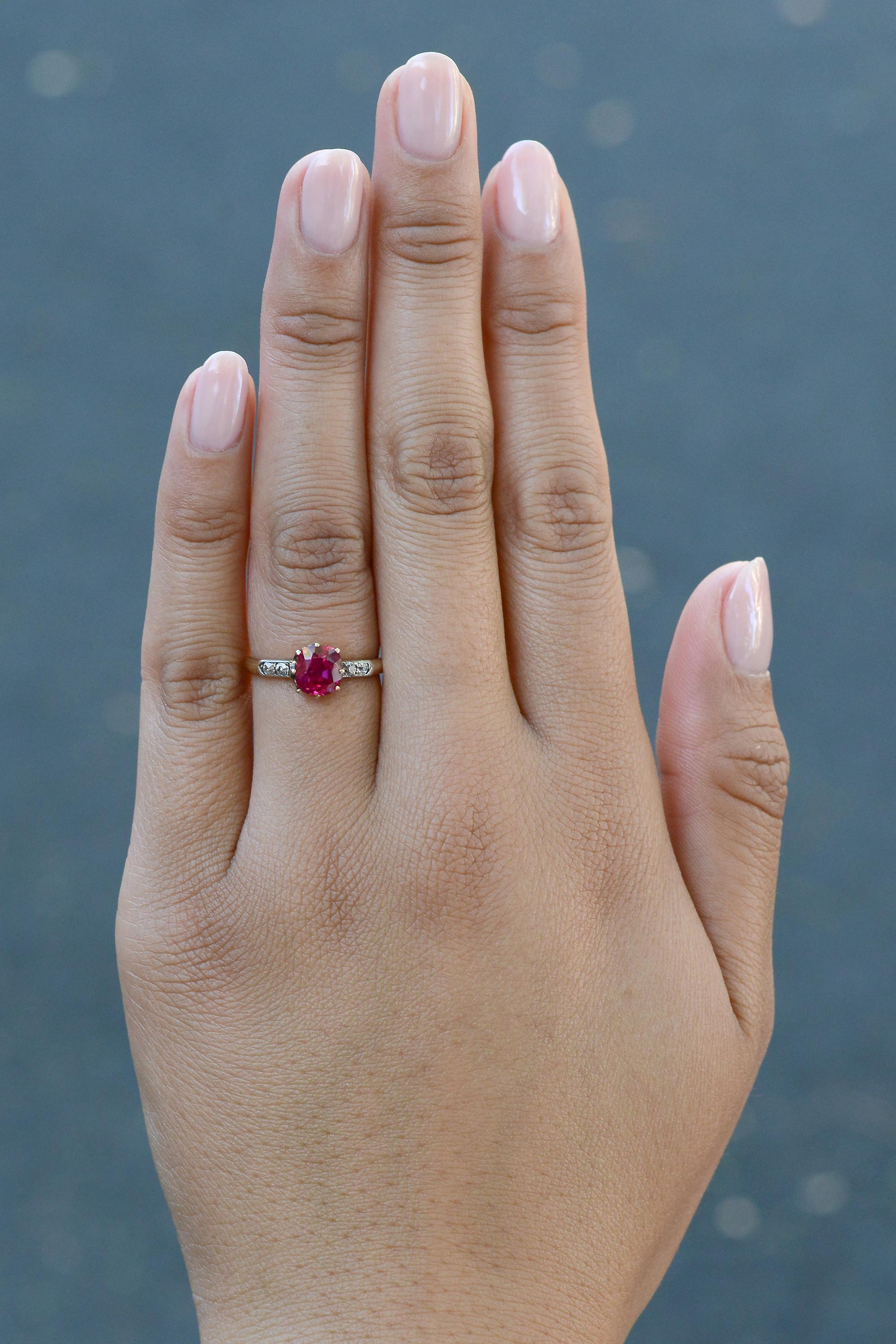 A stunning 1.86 carat Burmese ruby is the focal point of this superb Victorian era ring. The principal stone displays an intense purplish red, certified by American Gemological Laboratories with no indication of heat treatment and origin Burma