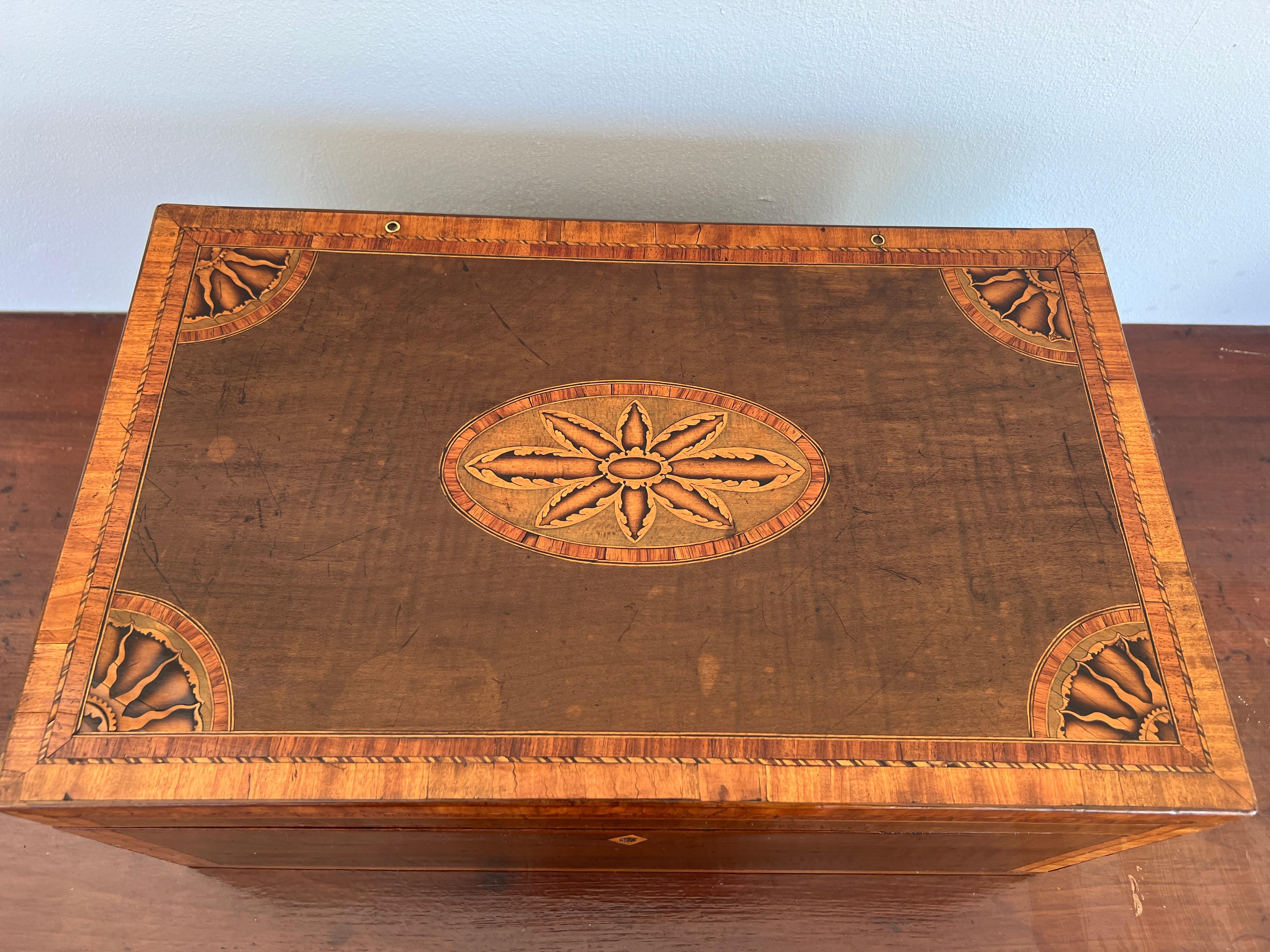 English, circa early 1800's. 

An exceptional and rare 19th century mahogany lap desk inlaid with impressive arrays of sunbursts to the corners and central sun form motif. These motifs have showed up on some of the best English pieces of furniture