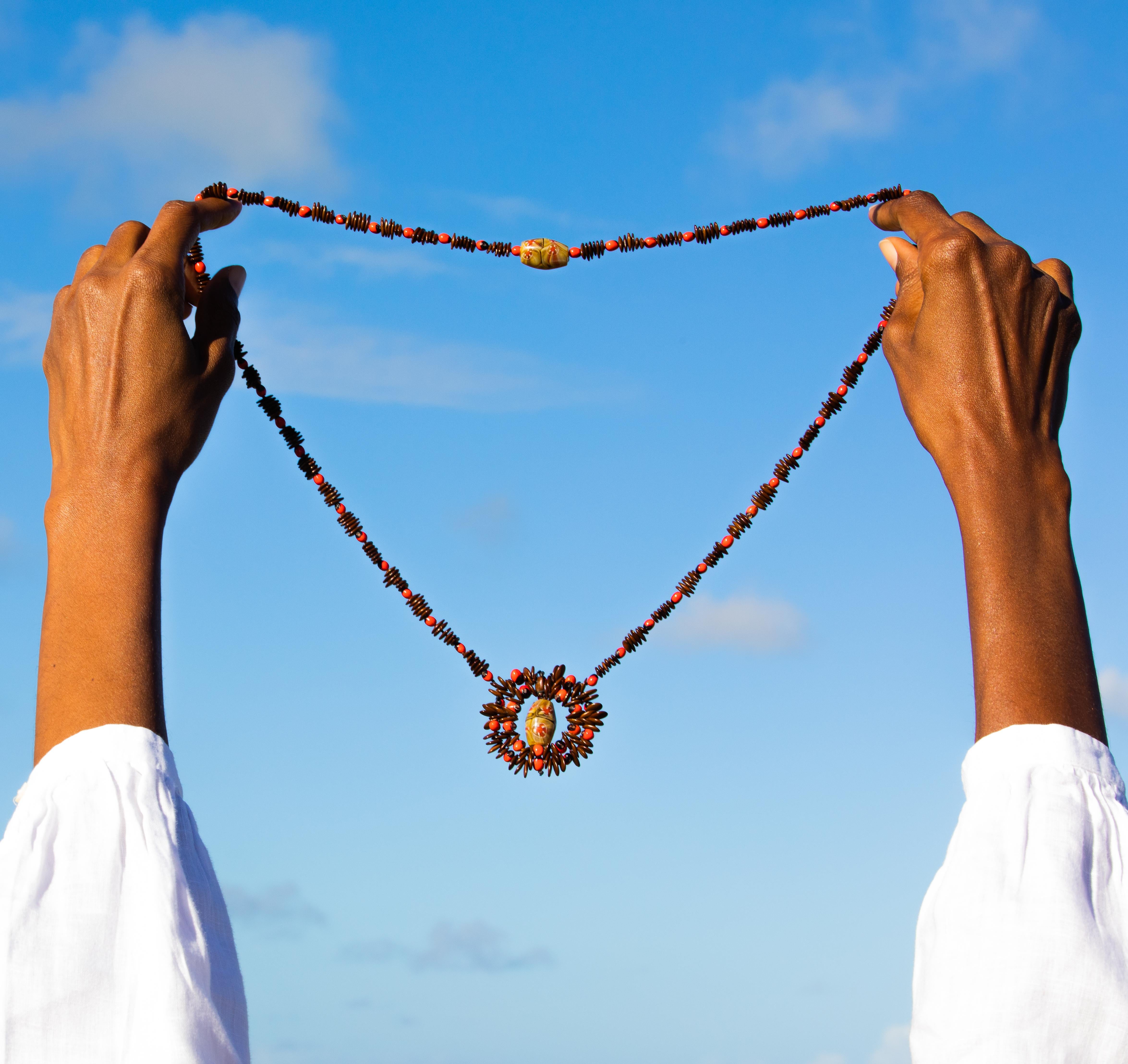 We pay tribute to our mother country by featuring our designer piece, The Best of Both Worlds.
Combining our traditional Antiguan Caribbeads with African glass beads, we honor our roots in this elegant necklace. The gentle swirling greens and reds