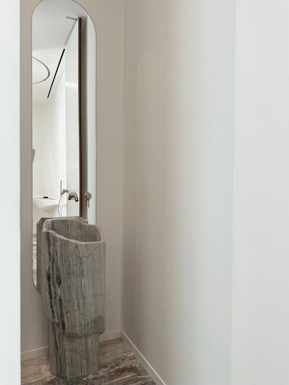 A one-of-a-kind creation in pristine white Persian marble. 

The vanity's sleek, sculptural form highlights the marble's luminous white surface and unique veining, offering a striking focal point for any sophisticated bathroom. 

Designed with both