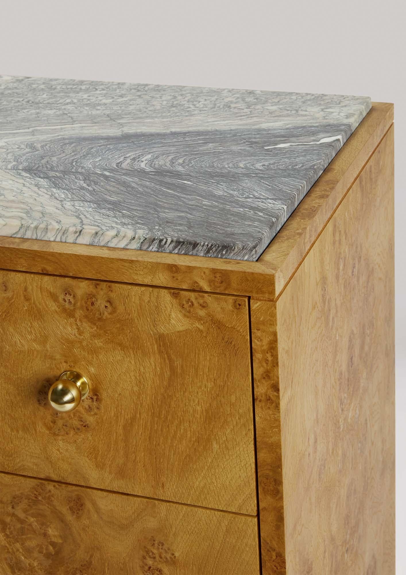 The Blewcoat Sideboard is handcrafted from luxurious Pippy Oak and crowned with a solid marble top, this sideboard is a statement piece for any space. Refined brass ball feet and handles add a touch of sophistication, while its soft-close drawer and