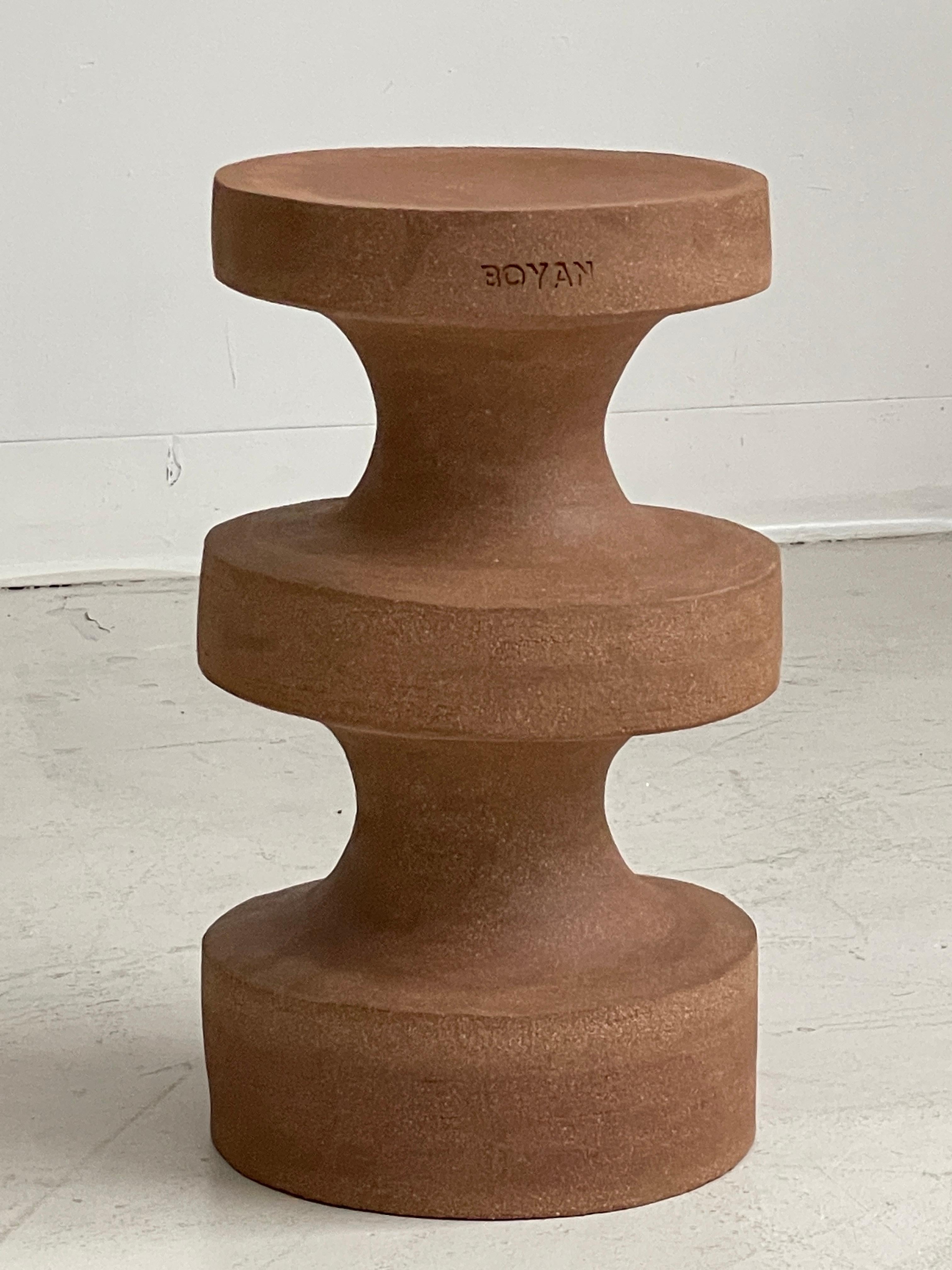 The Boyan side table by Zeynep Boyan
Dimensions: D 25.4 x H 43.18 cm
Materials: Terracotta stoneware clay.
This item is handmade. Due to the nature of the medium and human touch, slight variations are expected. 

The Boyan side table I is an