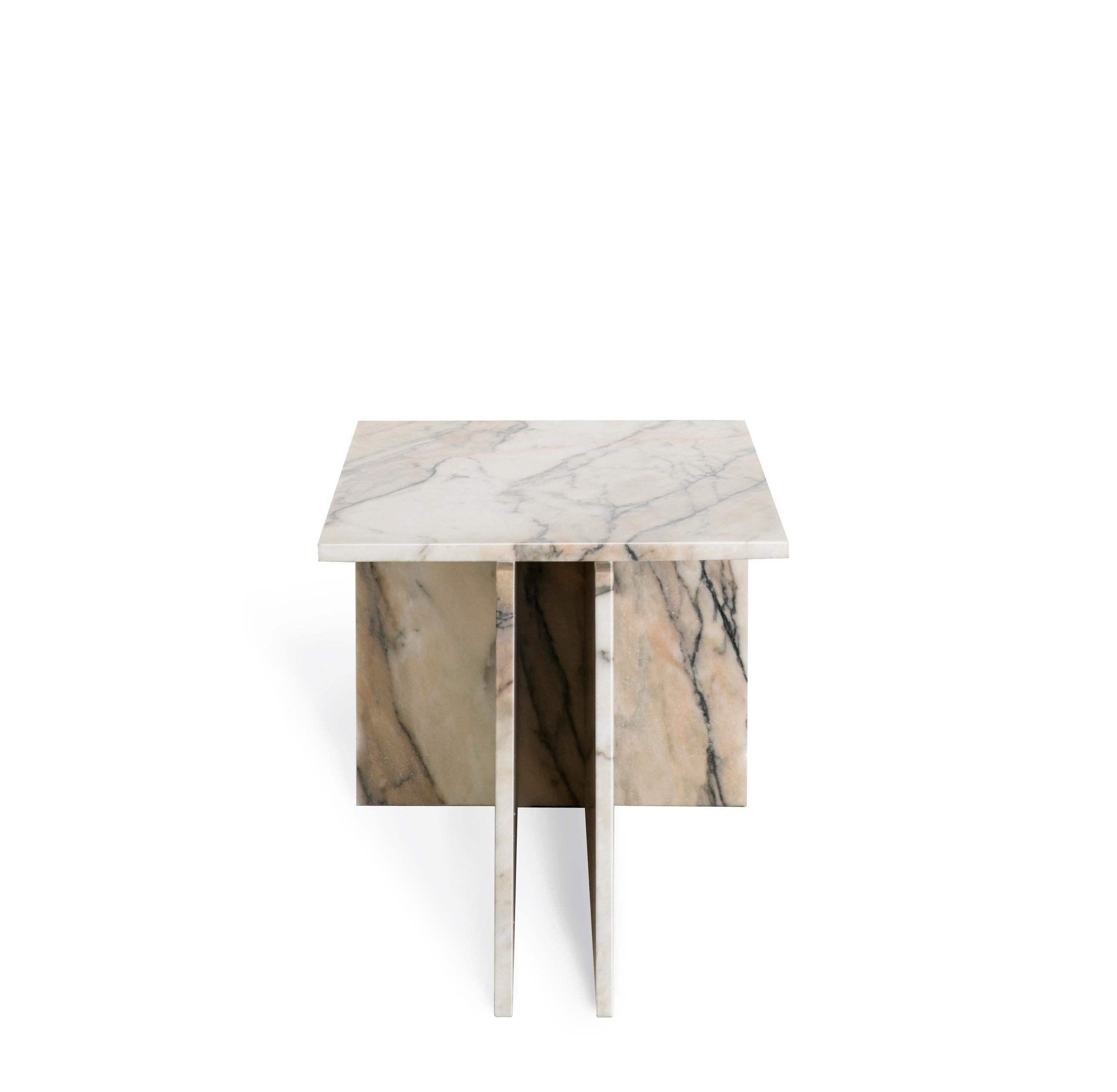 The 'Thé' table is a versatile table that can be used as a side table or coffee table.

Two vertical planes join to another plane, composing a T-shaped base for the top of the table. Produced in marble, it can be used in pairs (require 02 items to