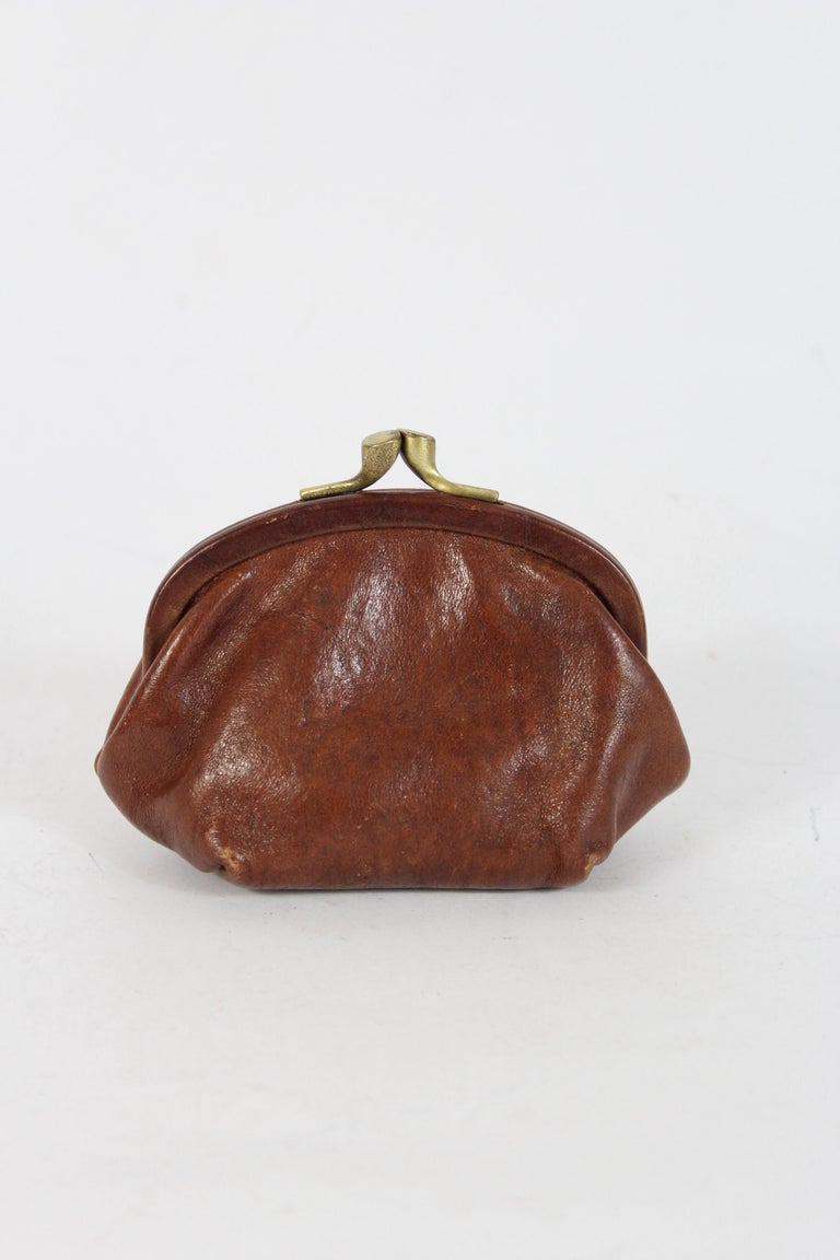 COURREGES. Round coin purse in brown leather with a silv…