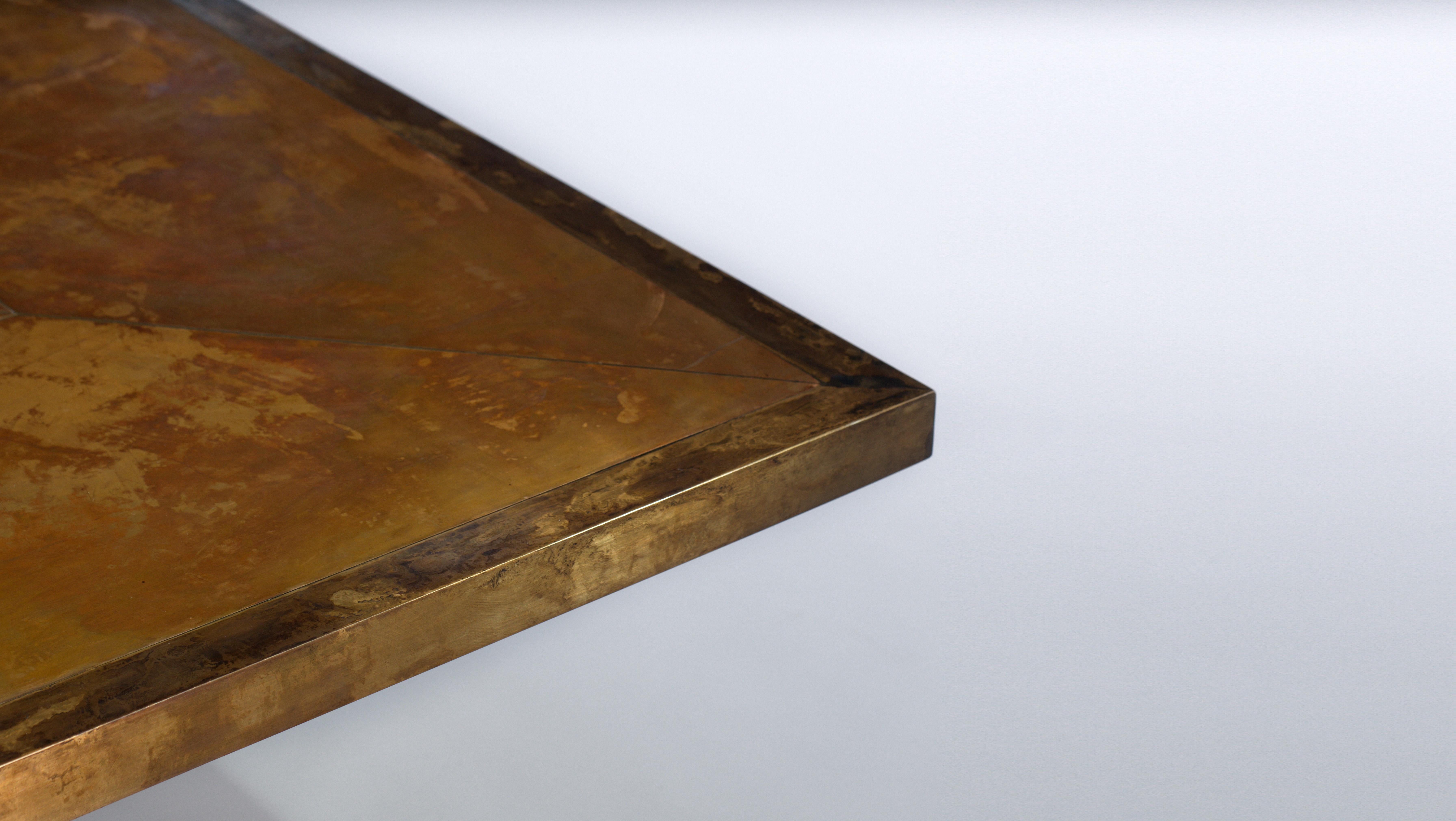 A patinated bronze coffee table. Plinth base in steel with an ebonized finish.
A sandwich cut bronze top, framed in a brass border. The rich marbled patination gives the feeling of constant movement.
It can be made to measure, therefore available