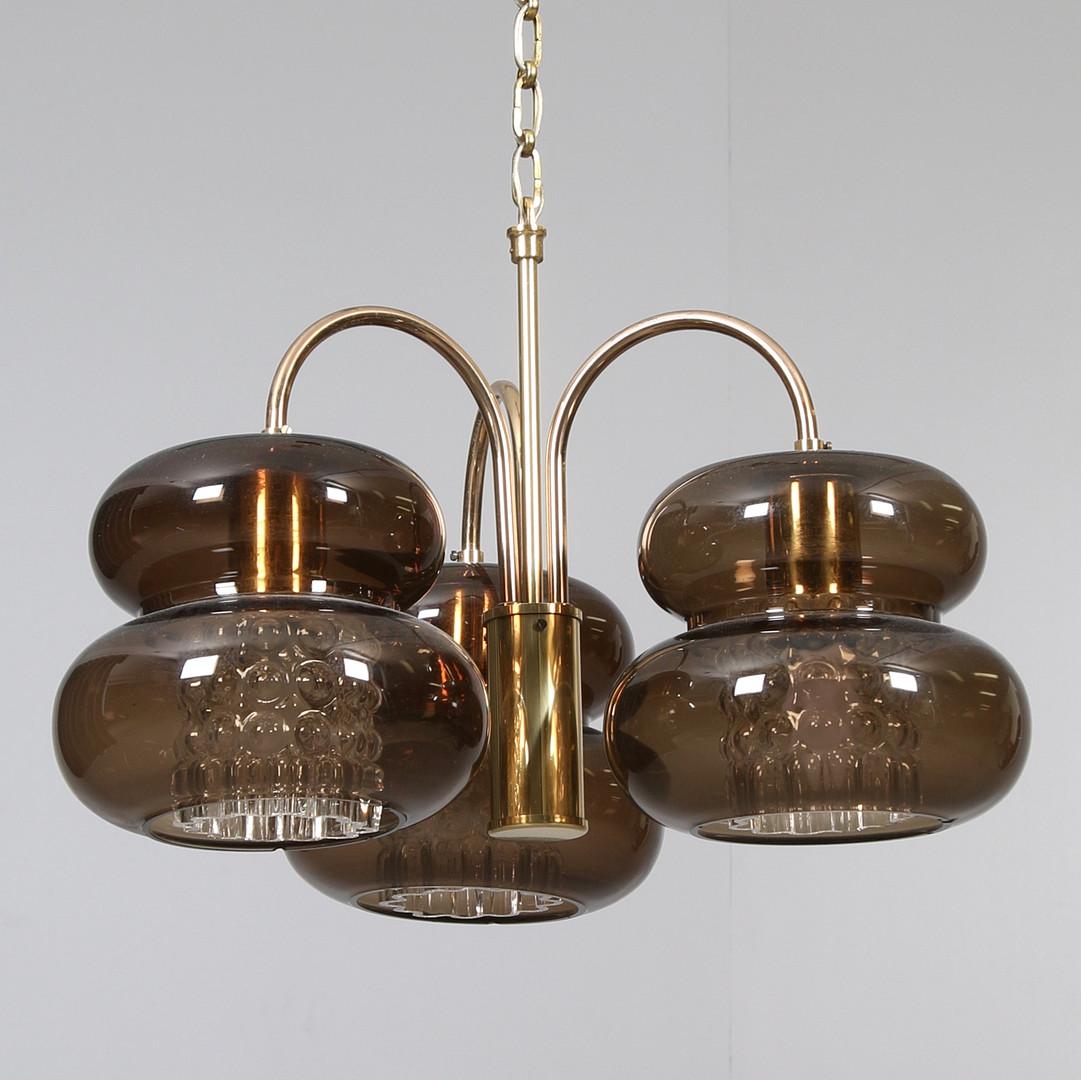 Brass construction with pressed glass and hand blown amber colored shades, designed in the 1960s in Sweden by Carl Fagerlund for Orrefors Glassworks.