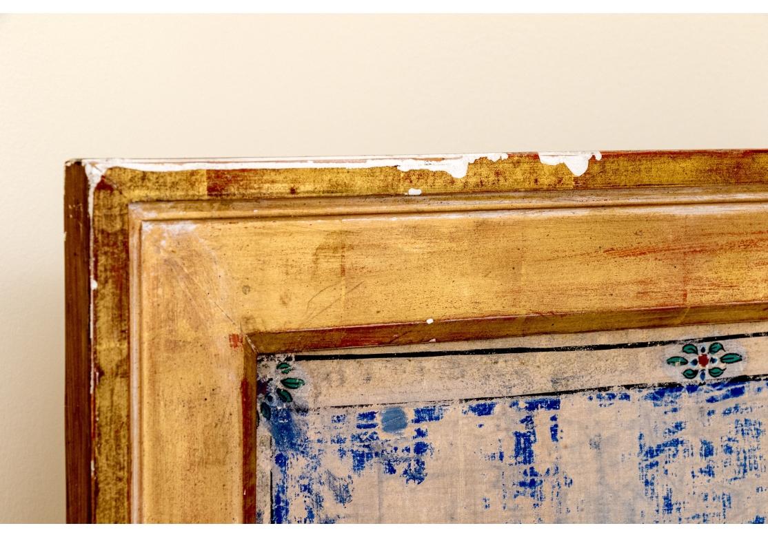 Watercolor and gouache on cloth mounted on wood depicting the Buddha and his two disciples Moggallana and Sariputta. Set inside a gold gesso & wood frame with attached brass light. Painted with the Buddha standing atop a lotus, his right hand raised