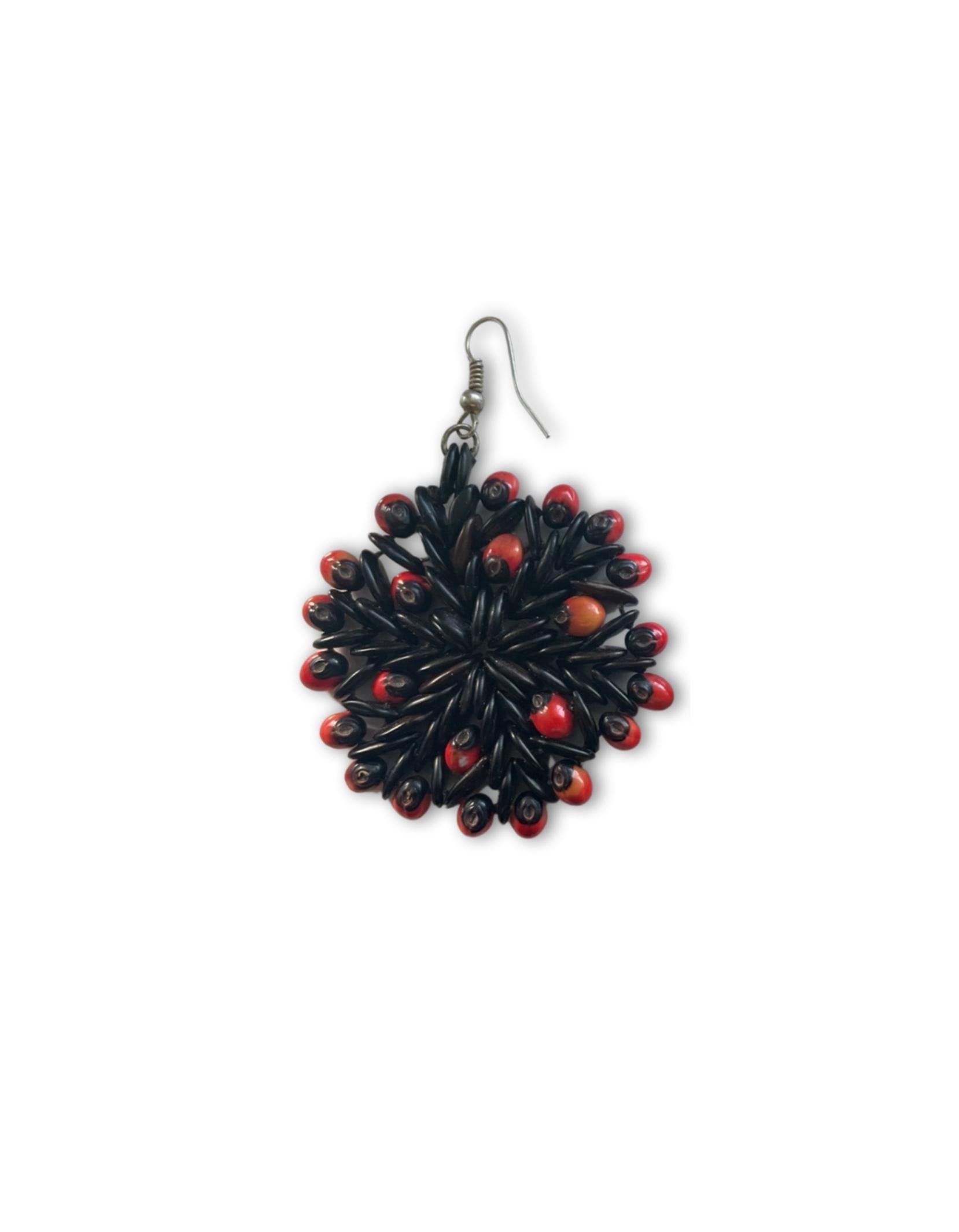 Capturing the mixture of tradition and vibrancy, this wild tamarind seed and jumbie bead seed earring will spark conversation at any cocktail hour. The rotunda design, highlighted with handpicked and Antiguan-sourced red jumbie bead seeds, is