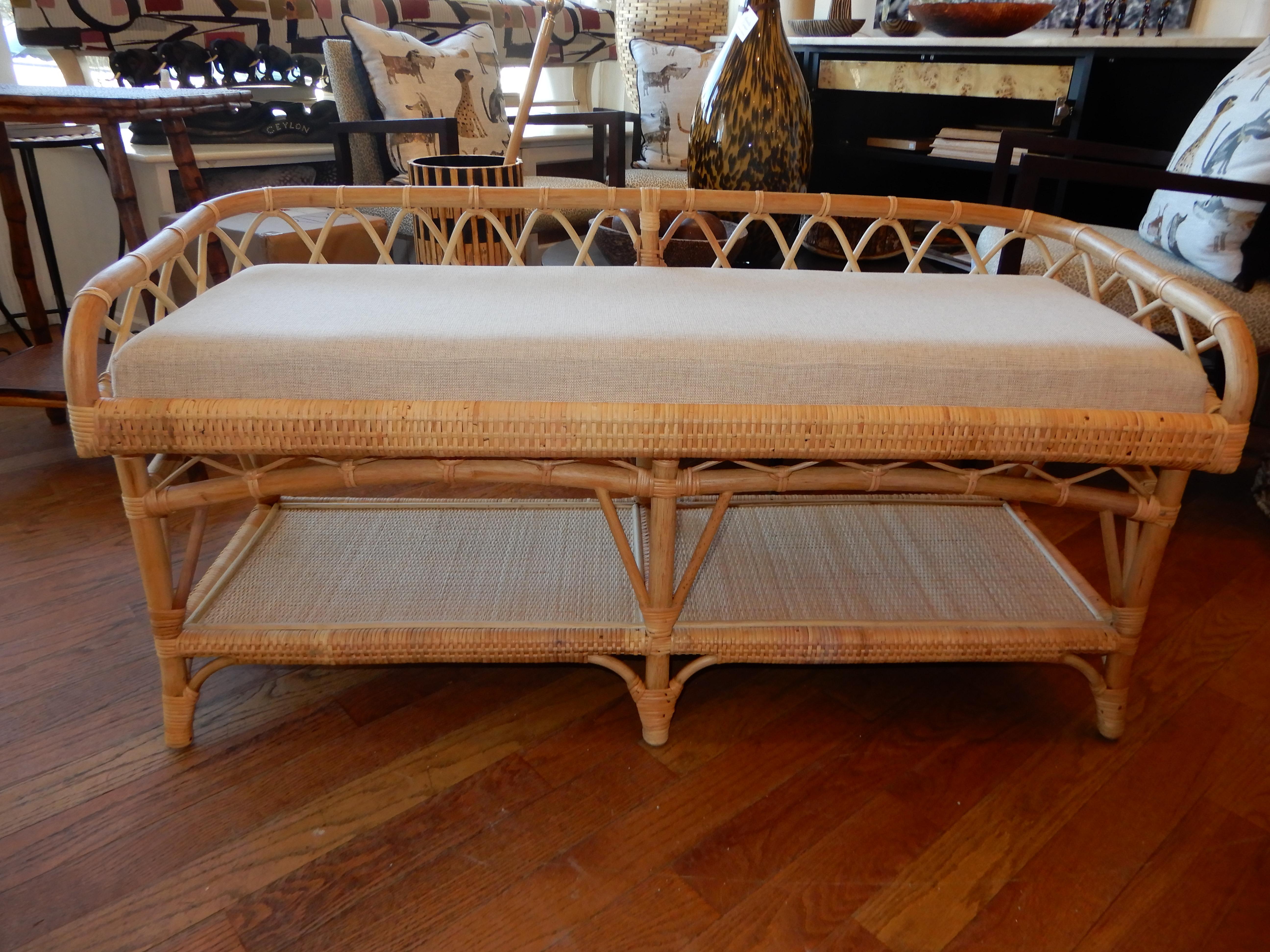 The Carolina Bench beautifully hand crafted in Spain of bamboo and cane. The seat is covered in a sunbrella natural tone fabric. The bottom level is great for books, shoes, towels depending on where you want the bench to work best for you. Great in