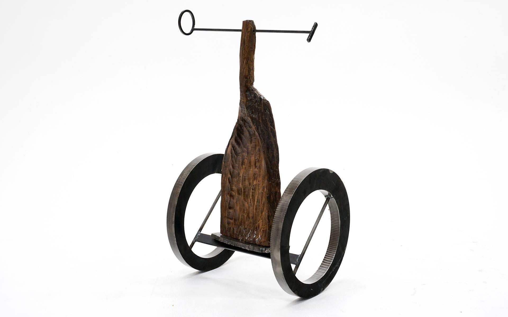 The Chariot by Dave Root is a kinetic piece that is not quite kinetic. It is directly inspired by Alberto Giacometti’s Le Chariot but interpreted on an asymmetrical plane in a non-figurative universe. In this iteration the chariot is out of balance