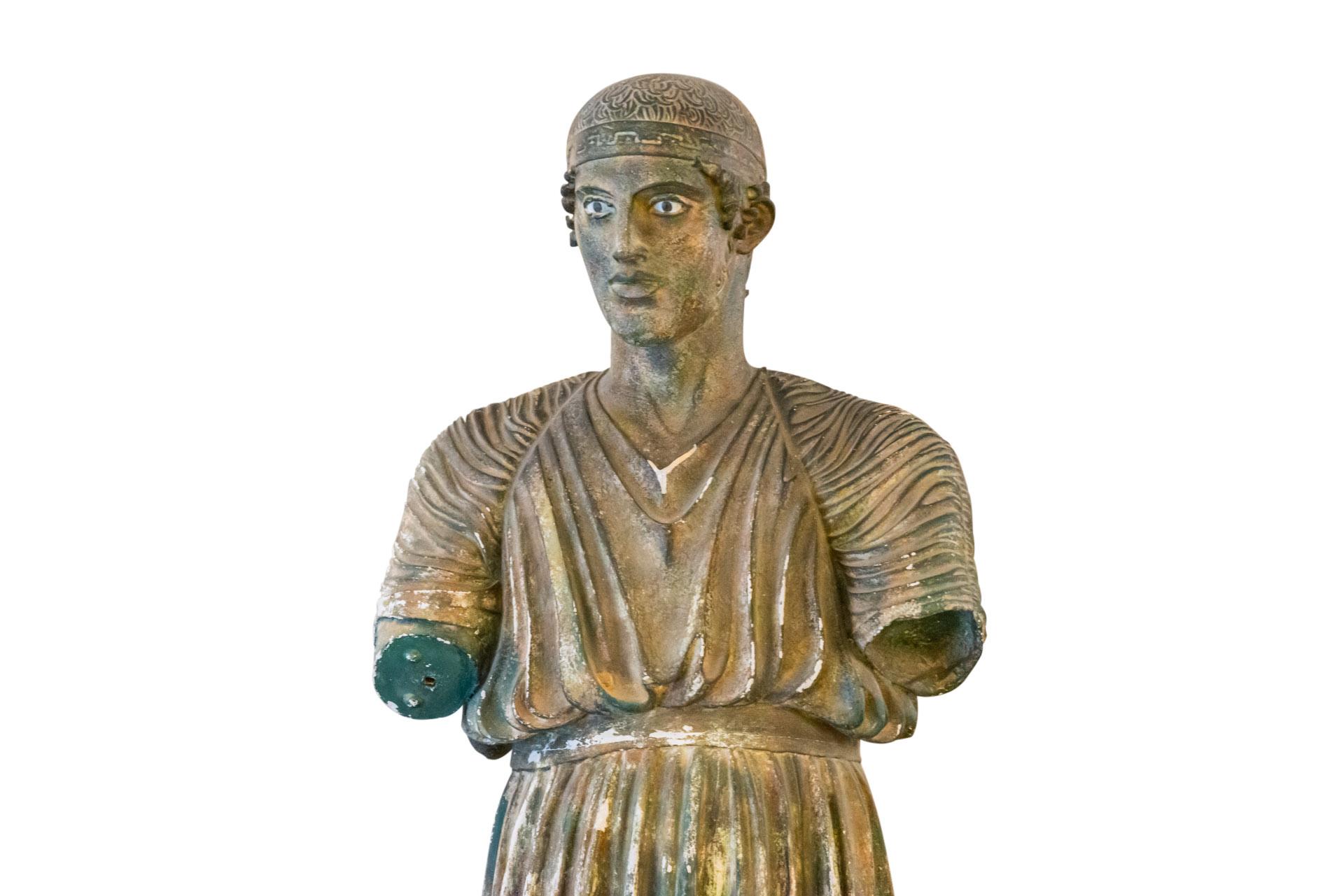 The Charioteer of Delphi, Plaster Sculpture,
Patina in the style of the Antique, reproduction of the Greek bronze,
Missing its right arm,
Vintage condition, some losses,
France, circa 1960.

Measures: Height 199 cm, Width 49 cm, Depth 40 cm.

The