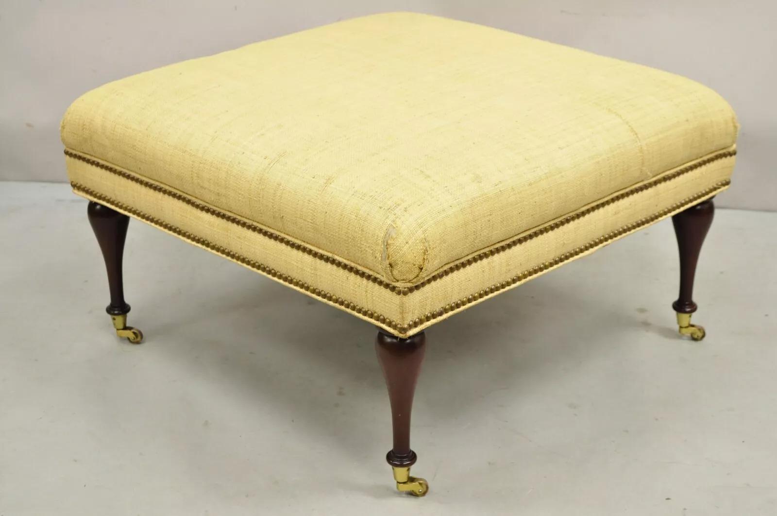 The Charles Stewart Co. Edwardian Style Mahogany Square Ottoman on Brass Castors. Circa Late 20th Century. Measurements: 17