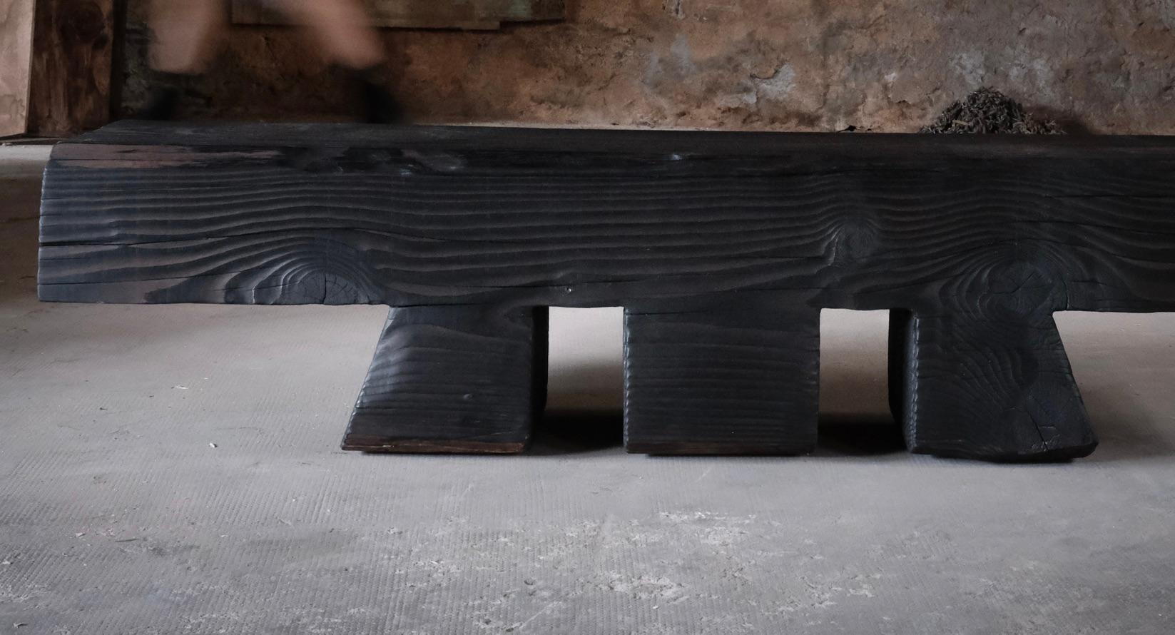 Hand-Carved Three-legged cedar hallway bench charred using the shou sugi ban tradition