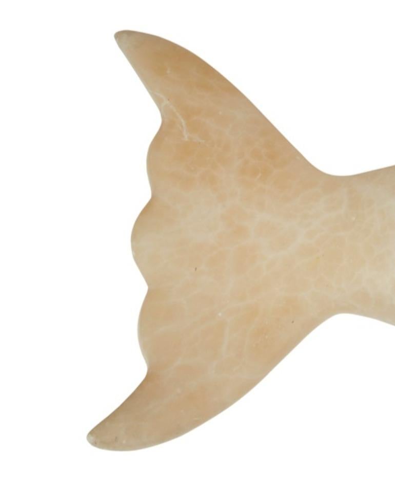 A wall sconce in the form of a chubby fish wonderfully carved from lustrous albino travertine stone. Could also be turned into a ceiling fixture or a table lamp, or displayed as a sculpture on stand.