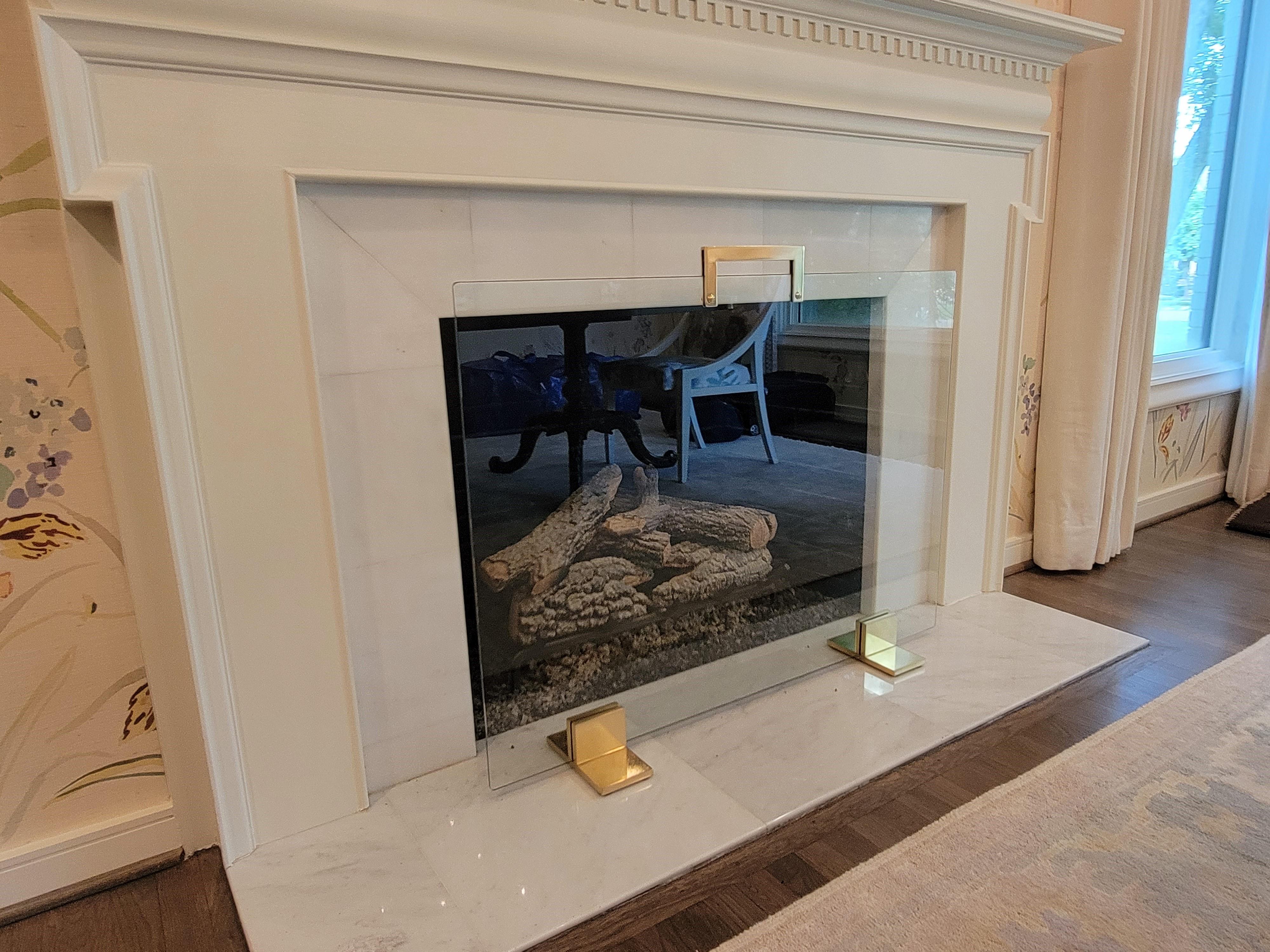 This is our Traditional Tempered Glass , Brass Feet firescreen which we have made hundreds for our local designers here in Dallas Fort Worth. We use solid brass and every one of our screens has heavy feet that are properly machined, 7 inch depth(