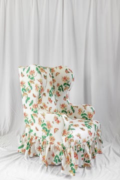 The Clementine Wing Chair, with Frilled Skirt upholstered in Honeysuckle