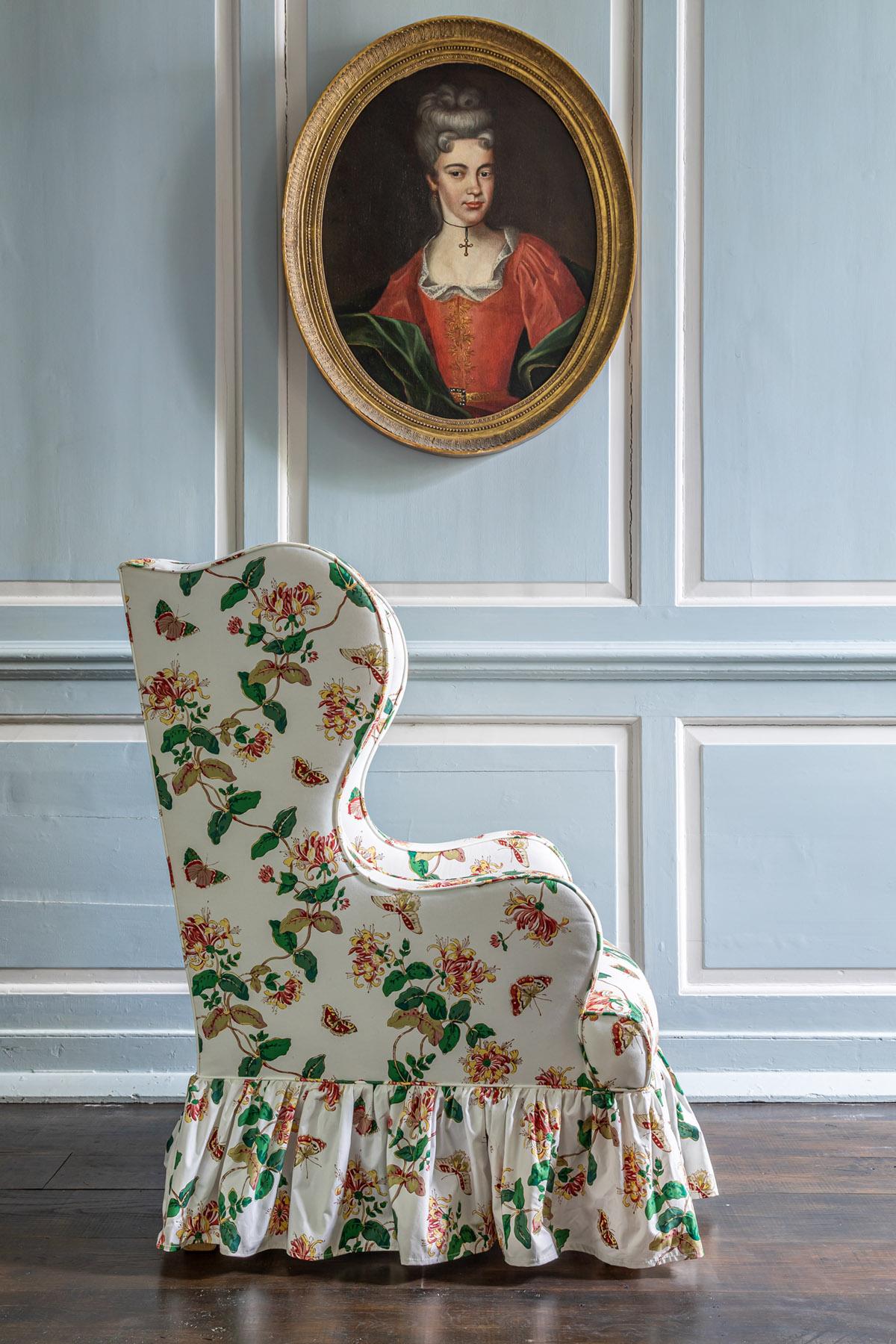 British The Clementine Wing chair with Frilled Skirt upholstered in Honeysuckle For Sale
