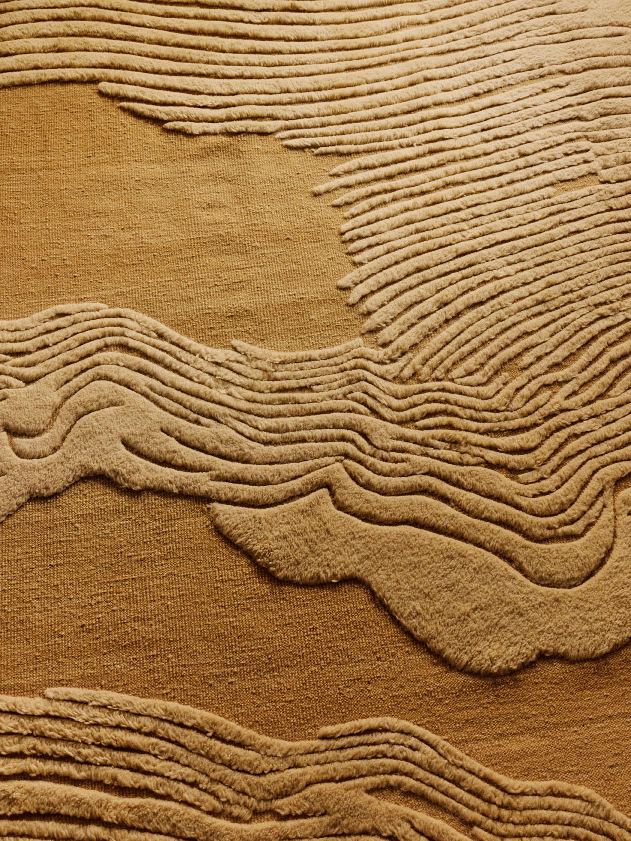 Tessuto in pura lana in un sapiente mix di trama piatta e vello tagliato, il tappeto Clouds invita al tatto e all'attenzione grazie alla sua superficie scultorea. La delicata tonalità paglierina dona un senso di calore e morbidezza a qualsiasi