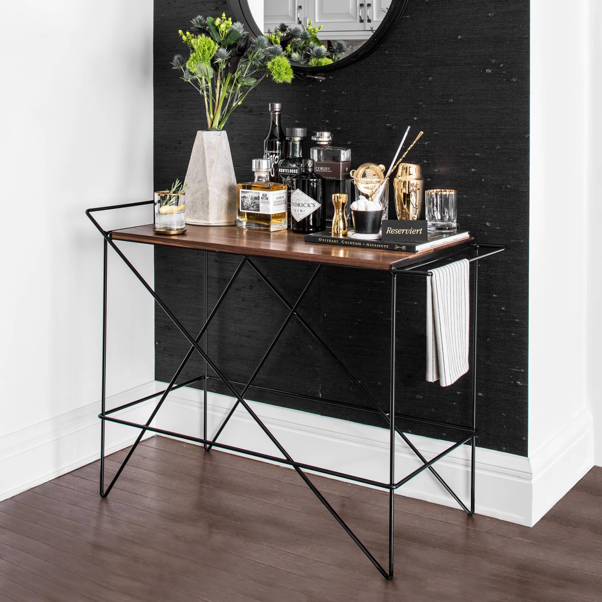 Day to day most bar carts aren't being rolled around, so The Coleman bar cart was designed to be a beautiful presentation and conversation piece while still light enough to remain functionally mobile. It is the result of a commission from Basil
