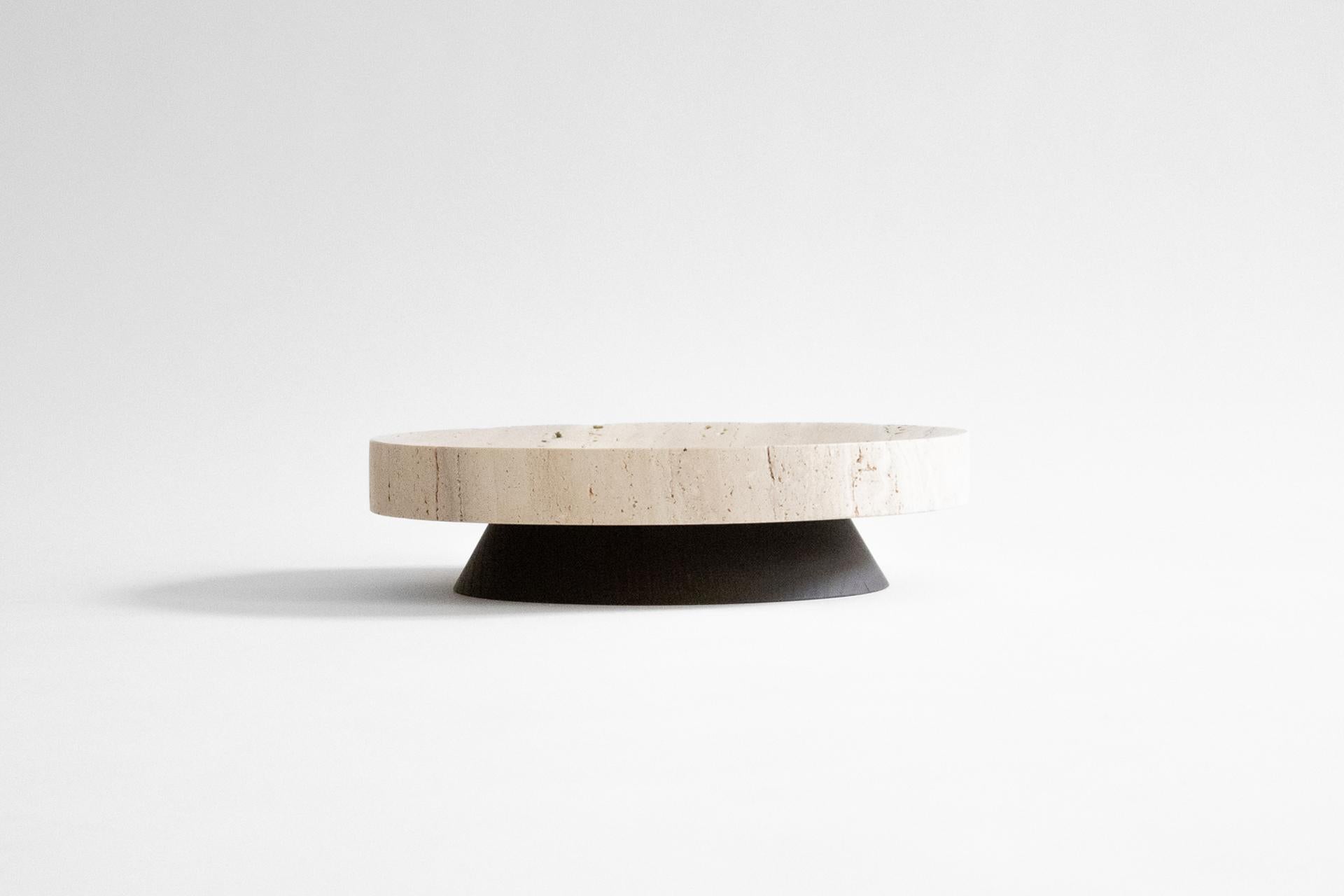 The Coliseu pedestals designed by Gabriel Tan, with the roman travertine tray made by Ricardo Eira and the smoked ash base made by Carlos Barbosa, are inspired by the amphitheaters of ancient Rome. The gently concave part of the wooden base matches