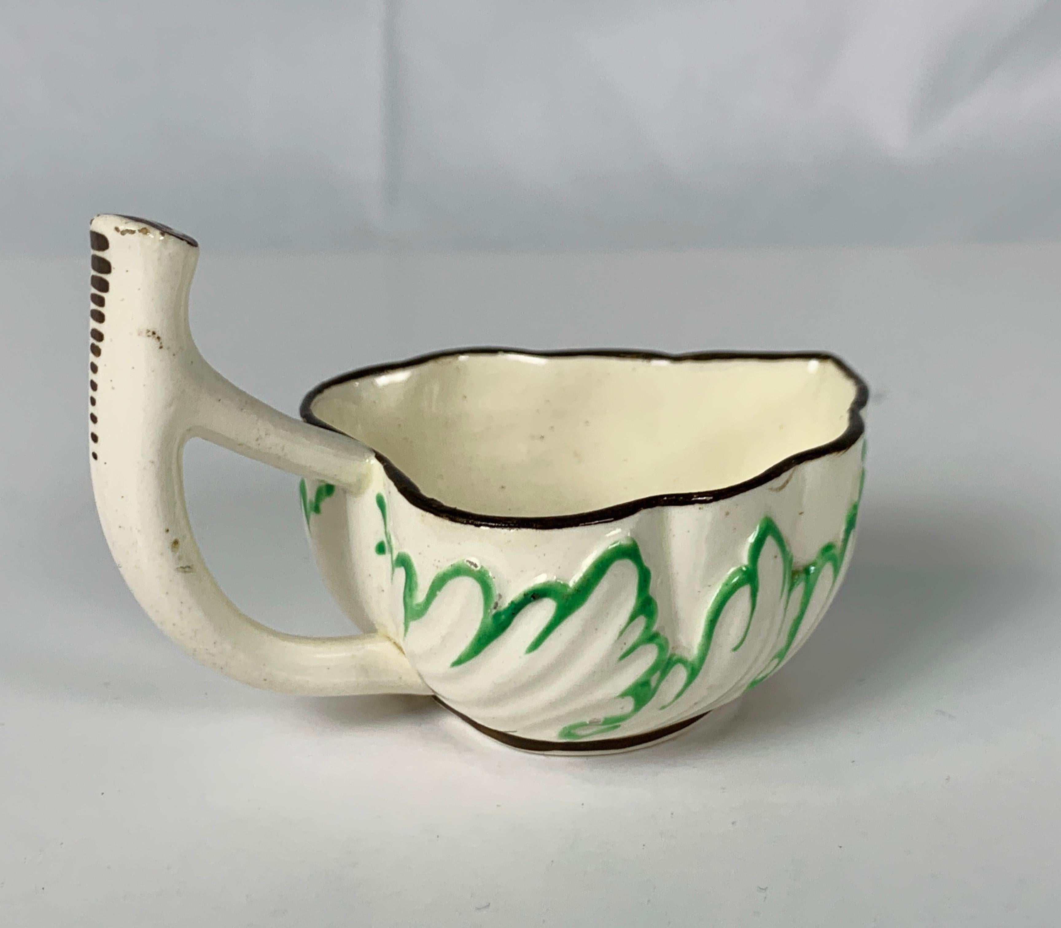 Provenance: The Private Collection of Mario Buatta, a creamware sweetmeat made in England circa 1790 with an impressed floral design outlined in lime green.
This sweetmeat might have been the odd part of a set which Mario purchased for a