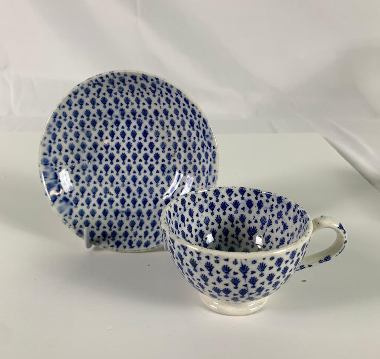 Provenance: The Private Collection of Mario Buatta
A blue and white English pottery teacup and saucer made in the Regency period, circa 1825. We see a delicate overall printed pattern showing small trees. This cup was made for a tea purist. It is