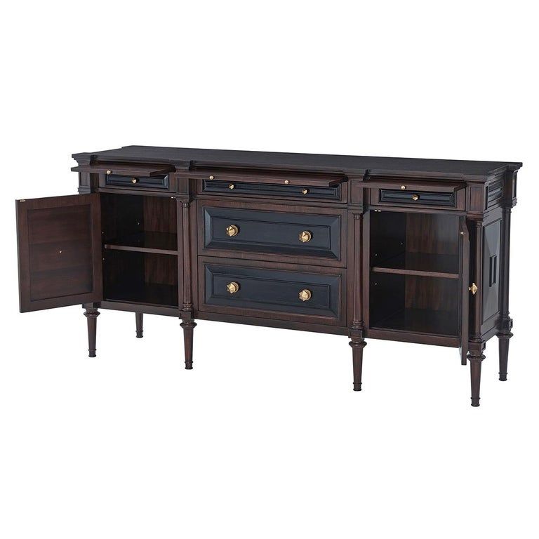 Boldly drawn breakfront-top sideboard beautifully serves form and function. Two central drawers and two relief-panel door compartments form the primary body of the sideboard buffet. Three baguette relief drawers with pullout trays offer extra