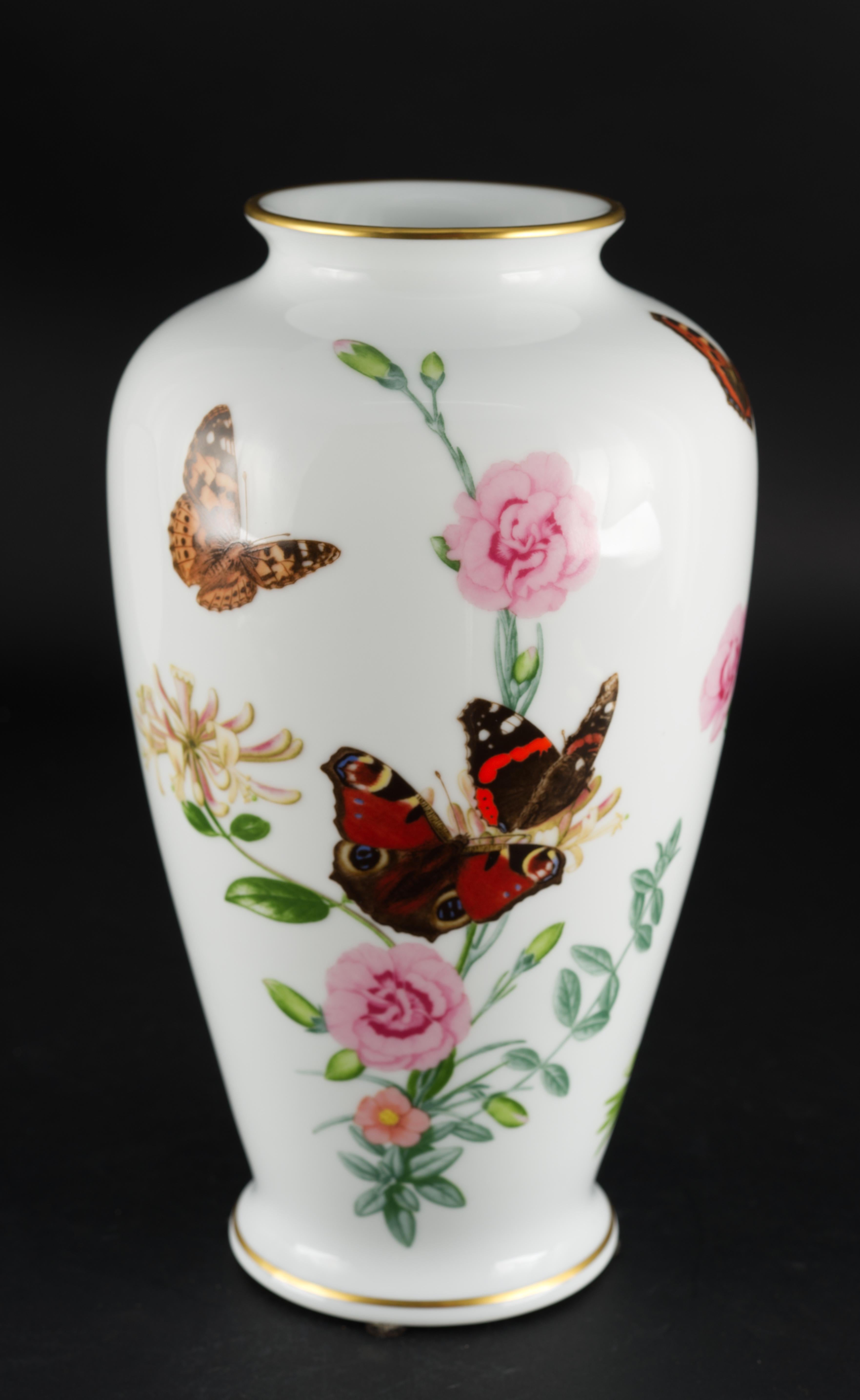 The Country Garden Butterfly Vase was designed by John Wilkinson for Franklin Porcelain. It is made of fine semi-translucent porcelain in traditional baluster shape as limited edition run in 1981. It is decorated with 3 different butterflies and